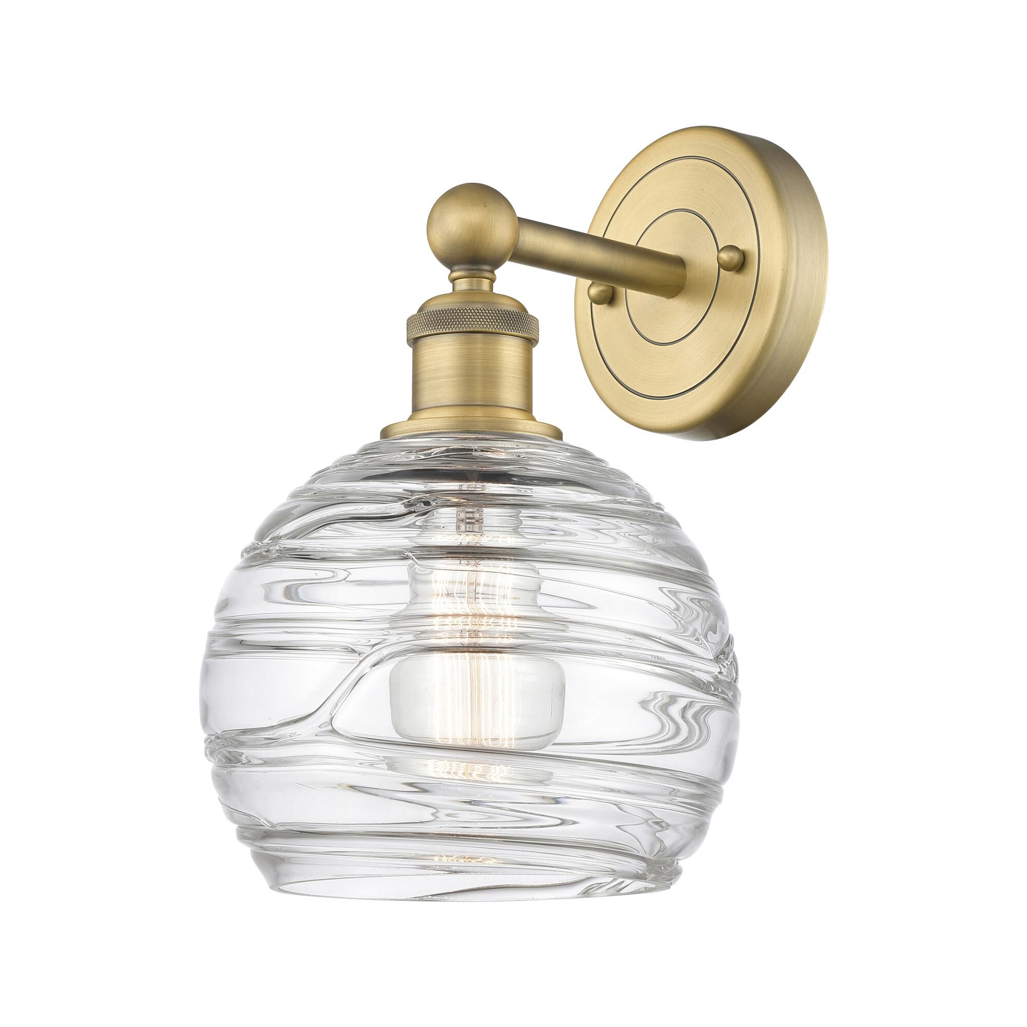 Shown in Brushed Brass finish and Clear Deco Swirl glass