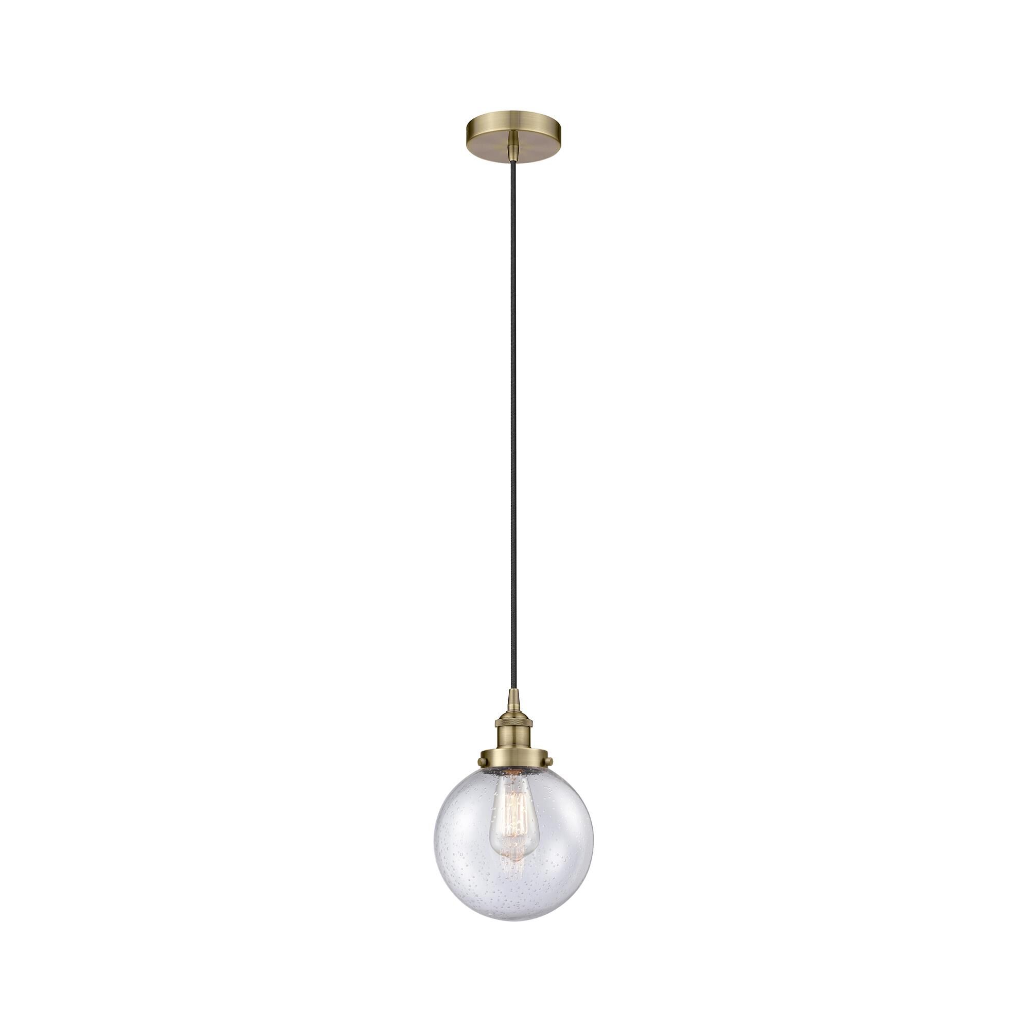 Shown in Antique Brass finish and Seedy Beacon glass