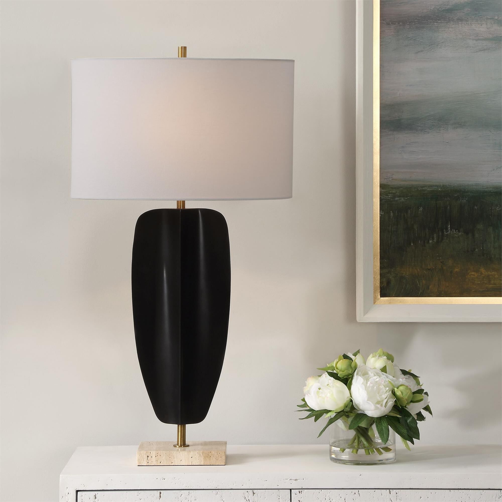 Shown in The Kure Table Lamp Is Crafted From Hand Forged Iron Finished In Matte Black, Replicating A Tribal S finish and Oval Hardback shade