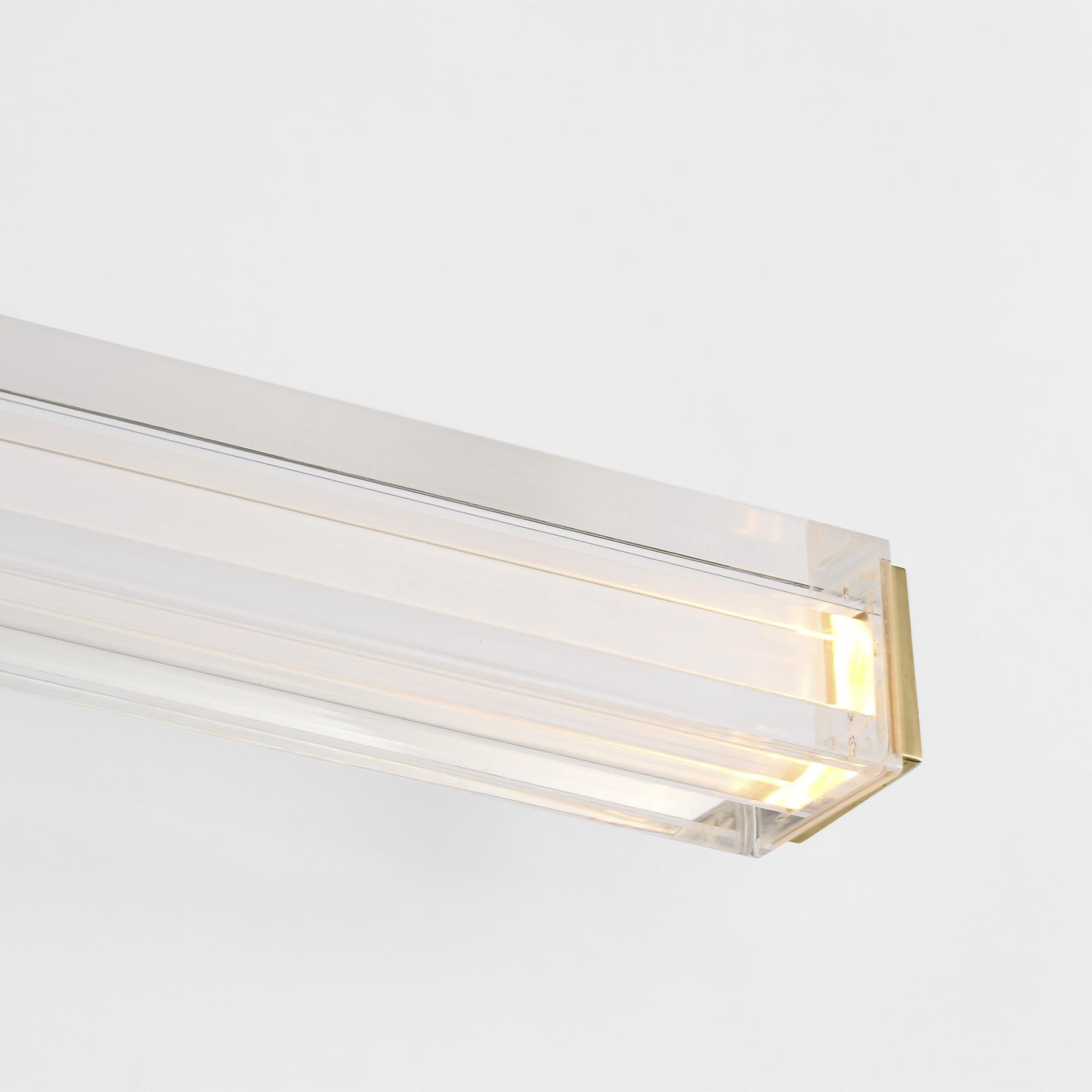 Shown in Hand-Rubbed Antique Brass finish and Clear Acrylic glass