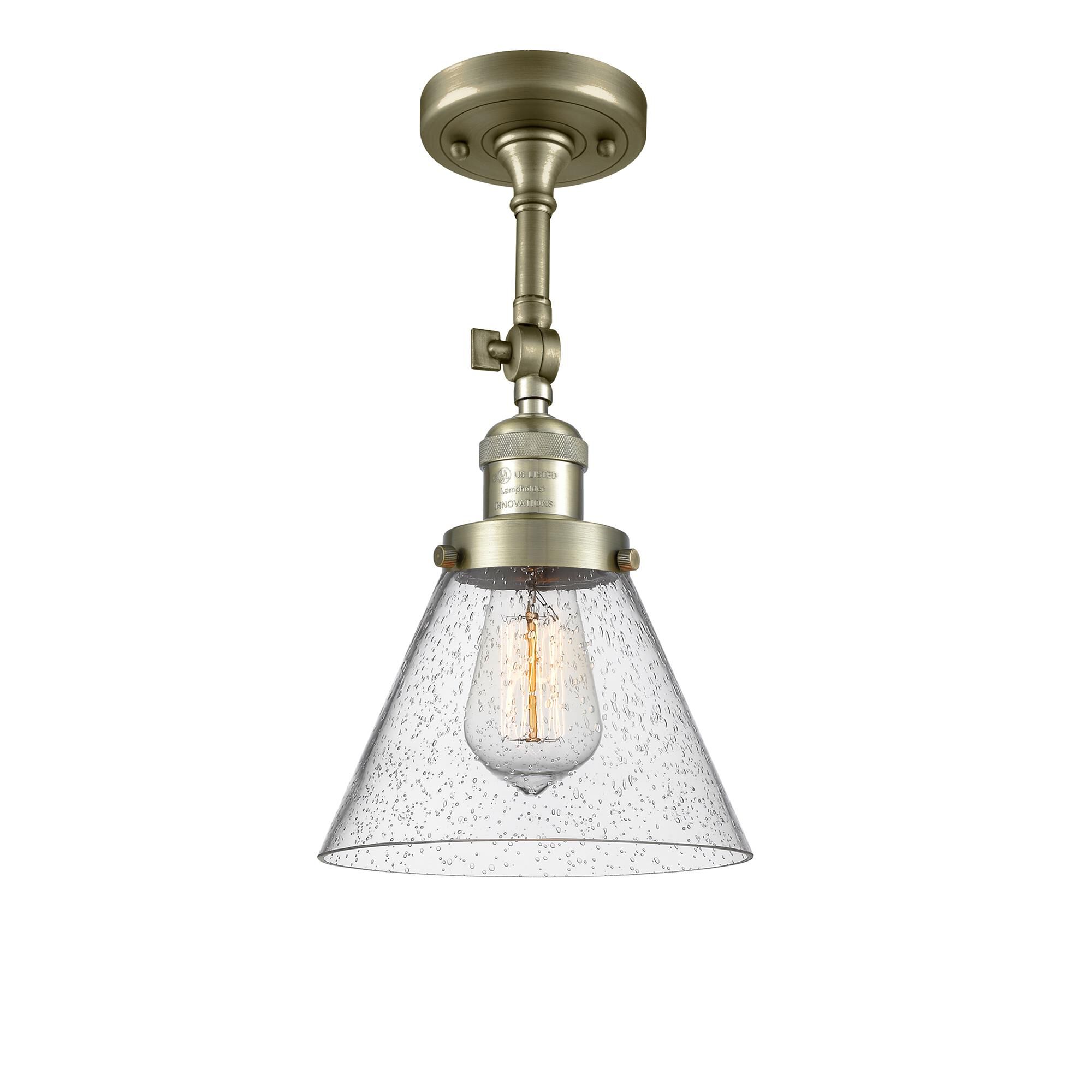 Shown in Antique Brass finish and Seedy glass