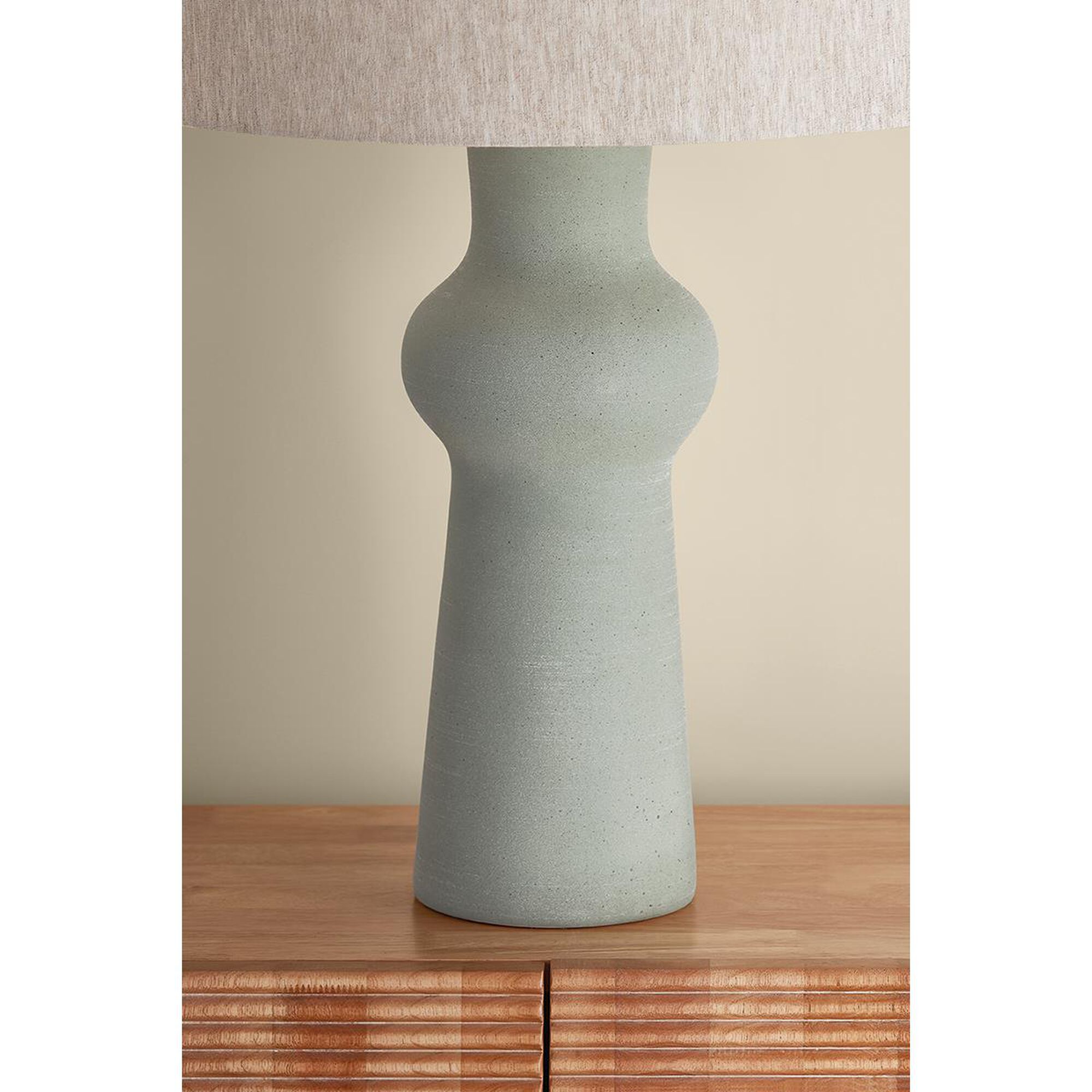 Shown in Aged Brass and Ceramic Hazy Jade finish and Natural Linen shade