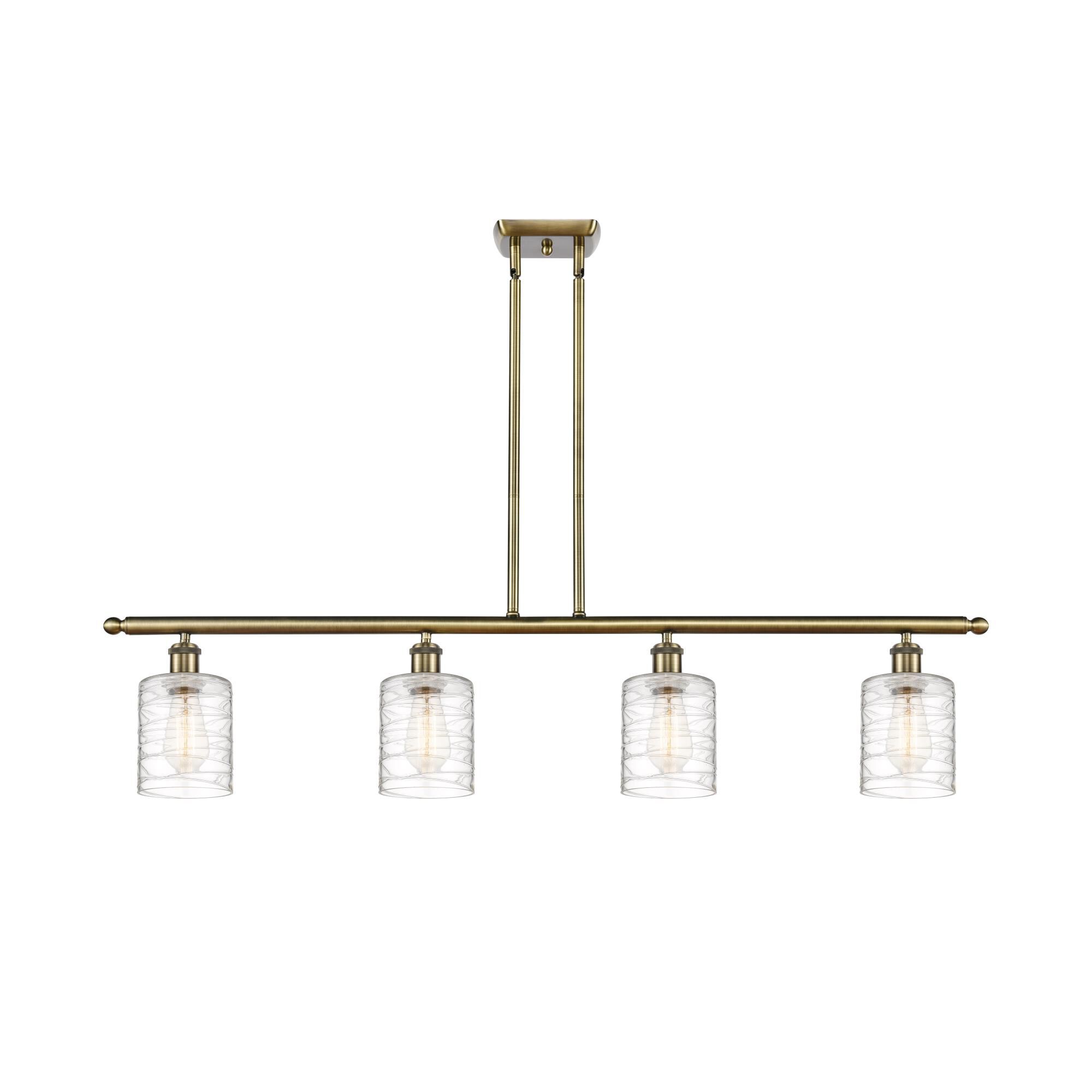 Shown in Antique Brass finish and Deco Swirl Cobbleskill glass