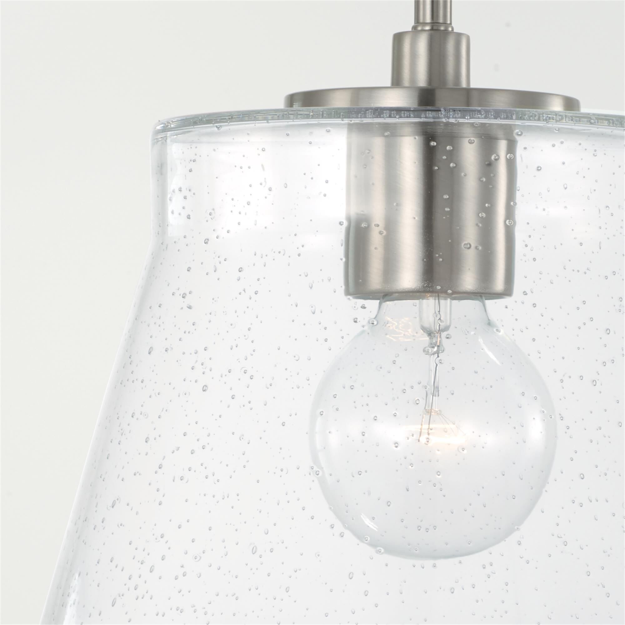 Shown in Brushed Nickel finish and Clear Seeded glass