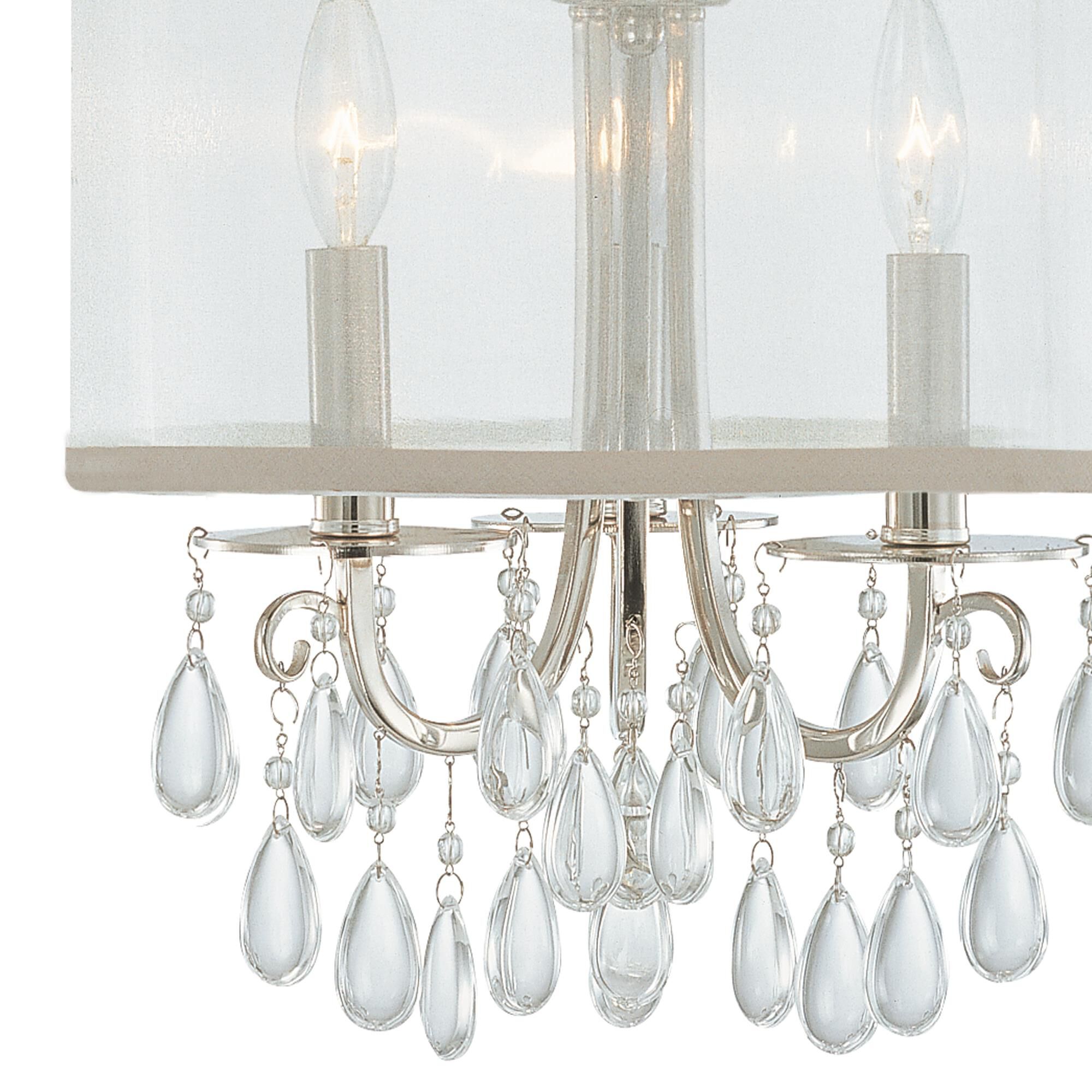 Shown in Polished Chrome finish and Clear Teardrop Almond crystal and Silk glass and Silk shade