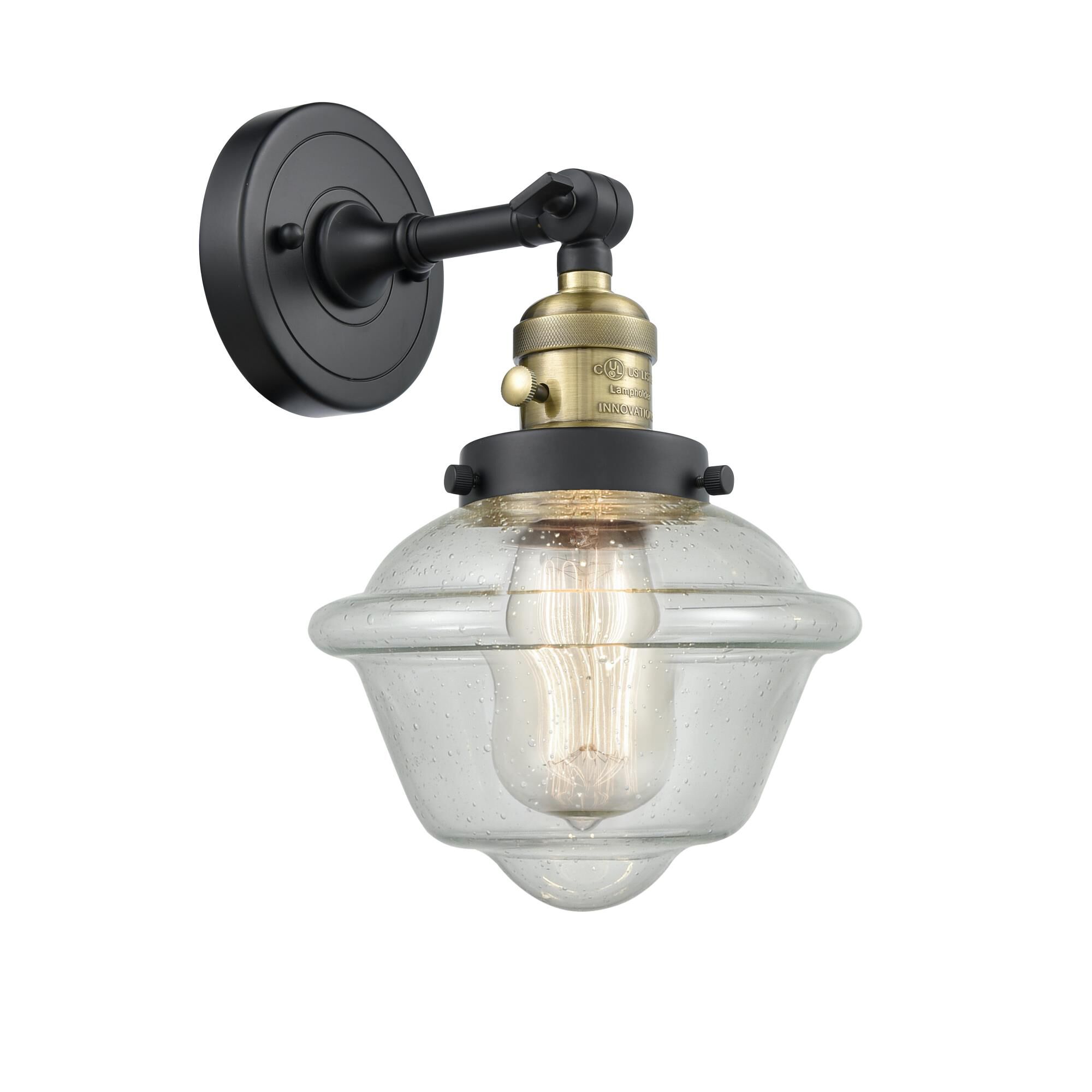 Shown in Black Antique Brass finish and Seedy glass and Switch on Socket accent