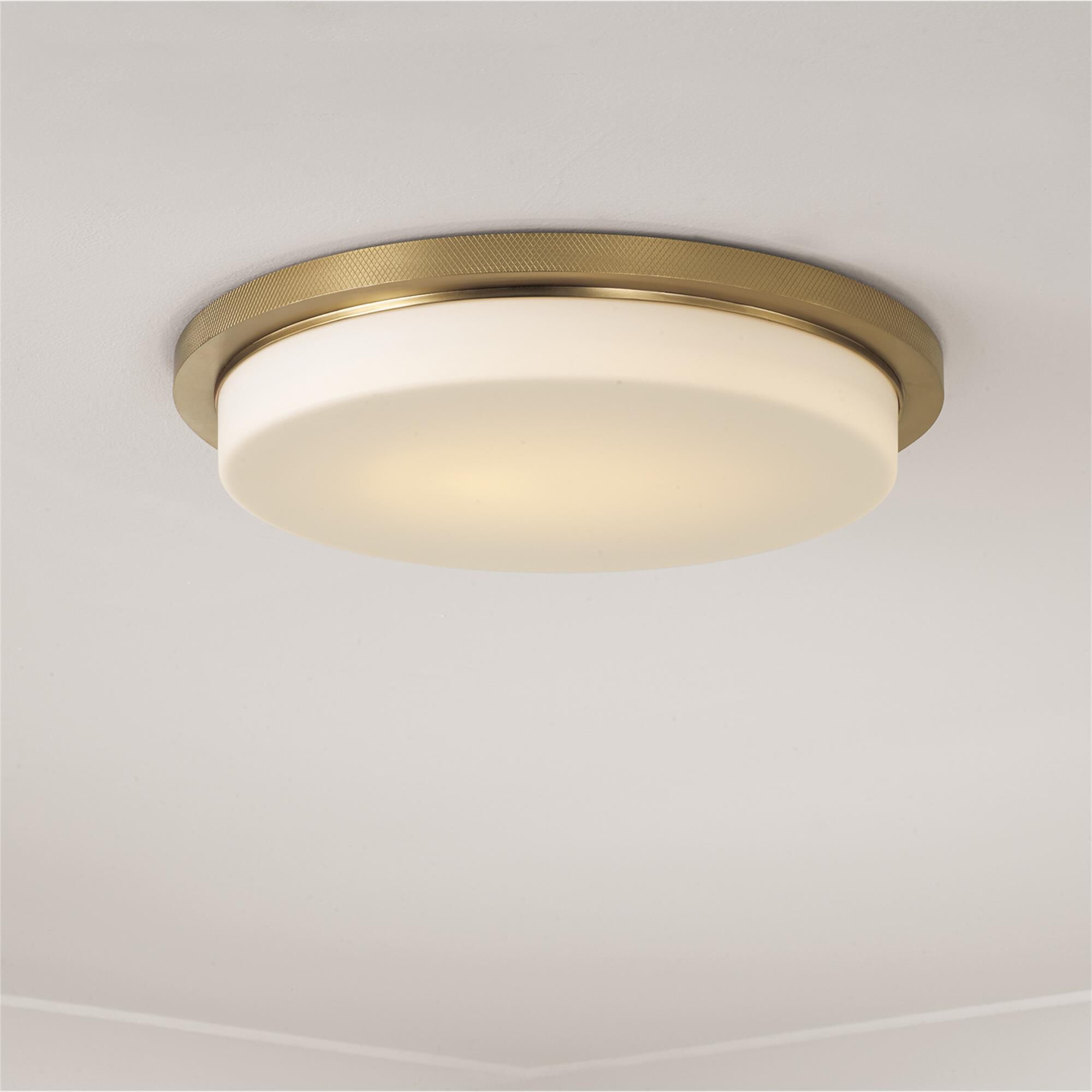 Shown in Aged Brass finish and Soft White glass