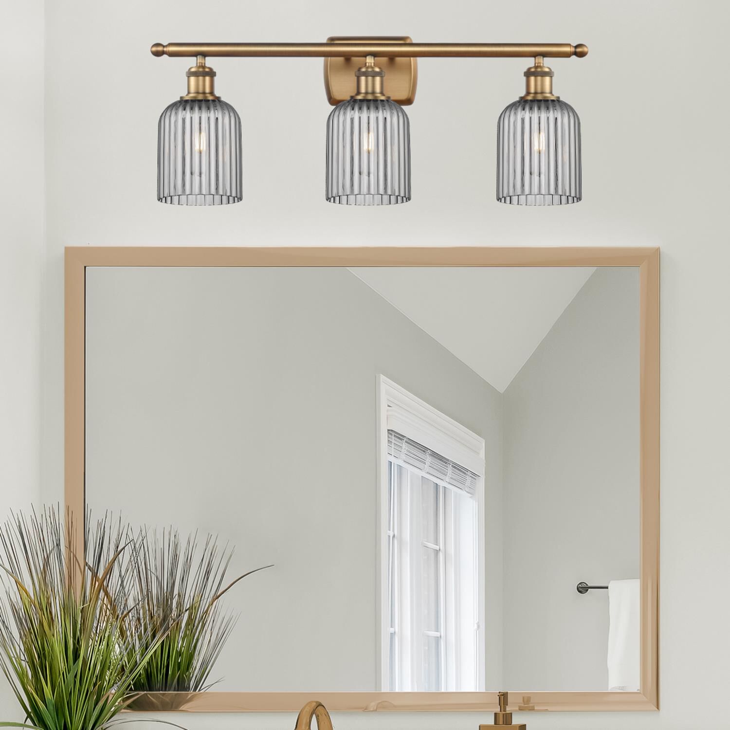 Shown in Brushed Brass finish and Light Smoke glass