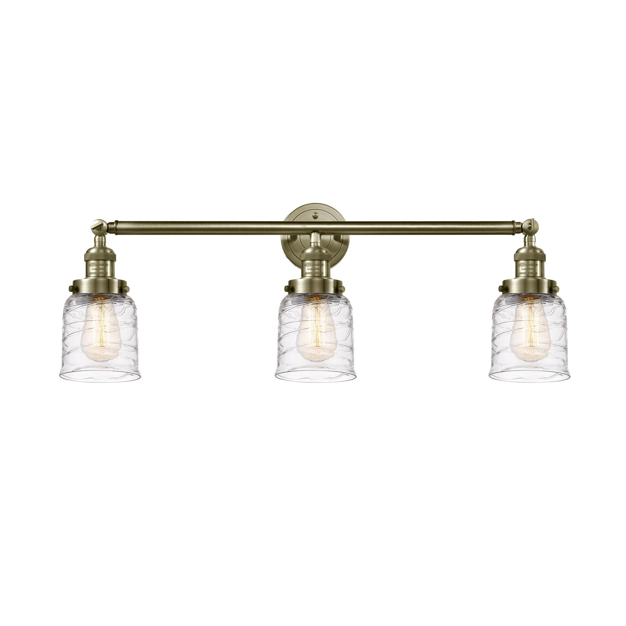 Shown in Antique Brass finish and Clear Deco Swirl glass