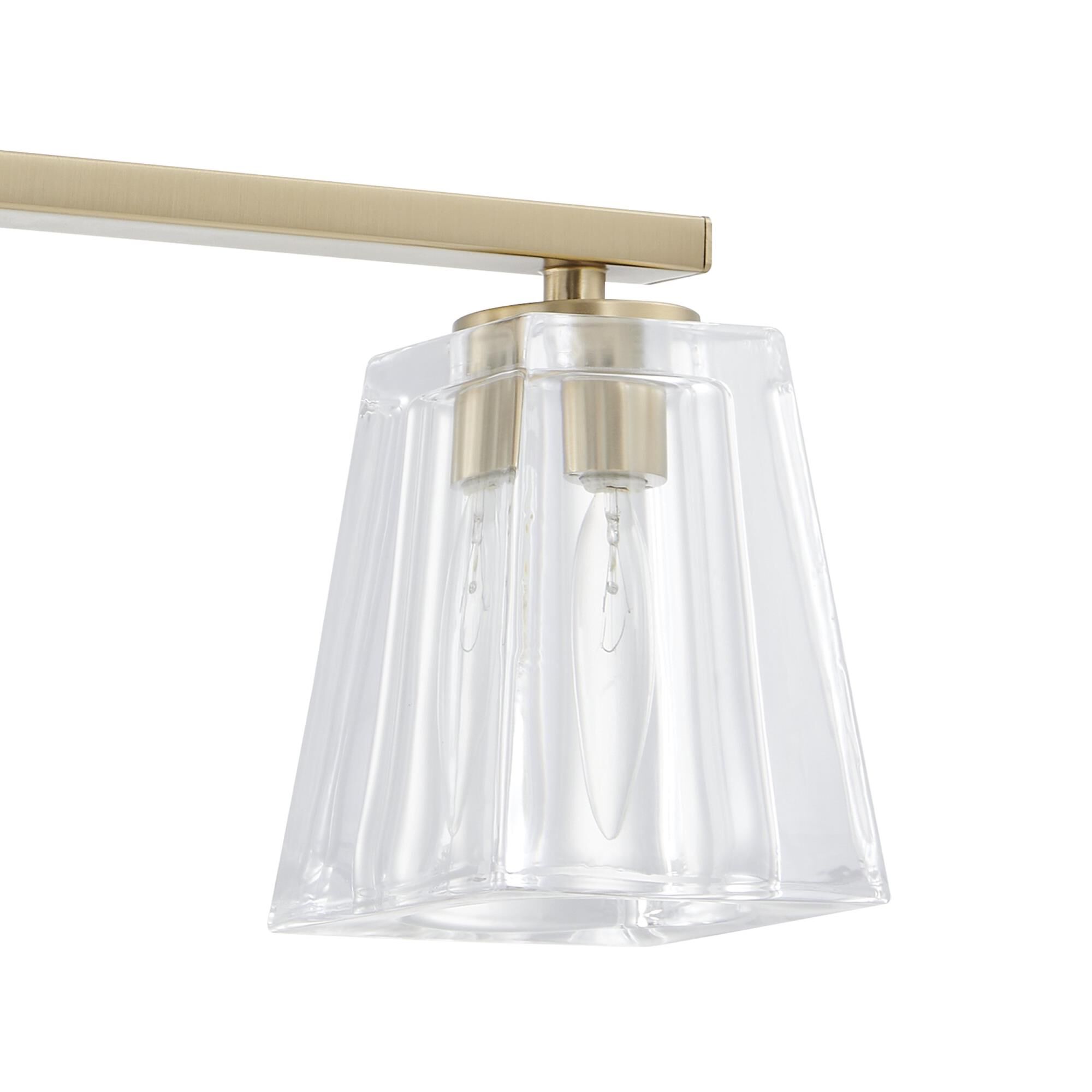 Shown in Champagne Gold finish and Clear Pressed glass