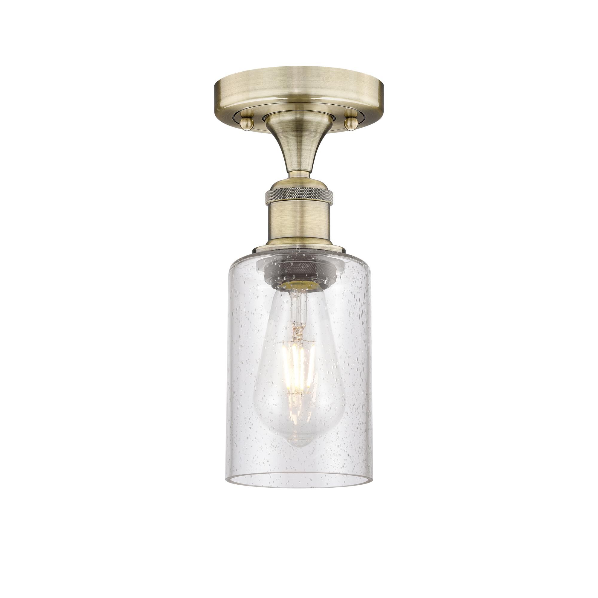 Shown in Antique Brass finish and Seedy glass