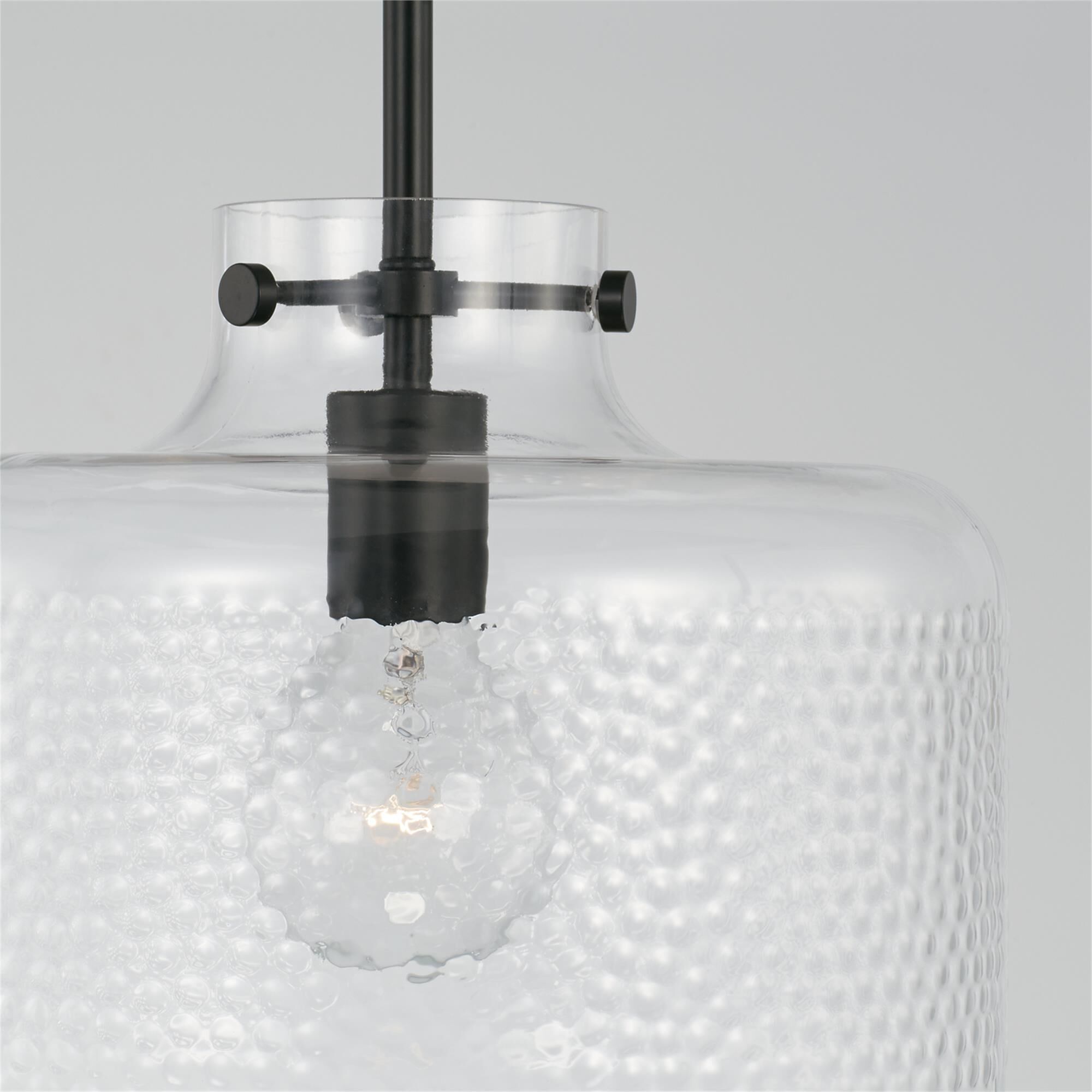 Shown in Matte Black finish and Clear Pebbled glass