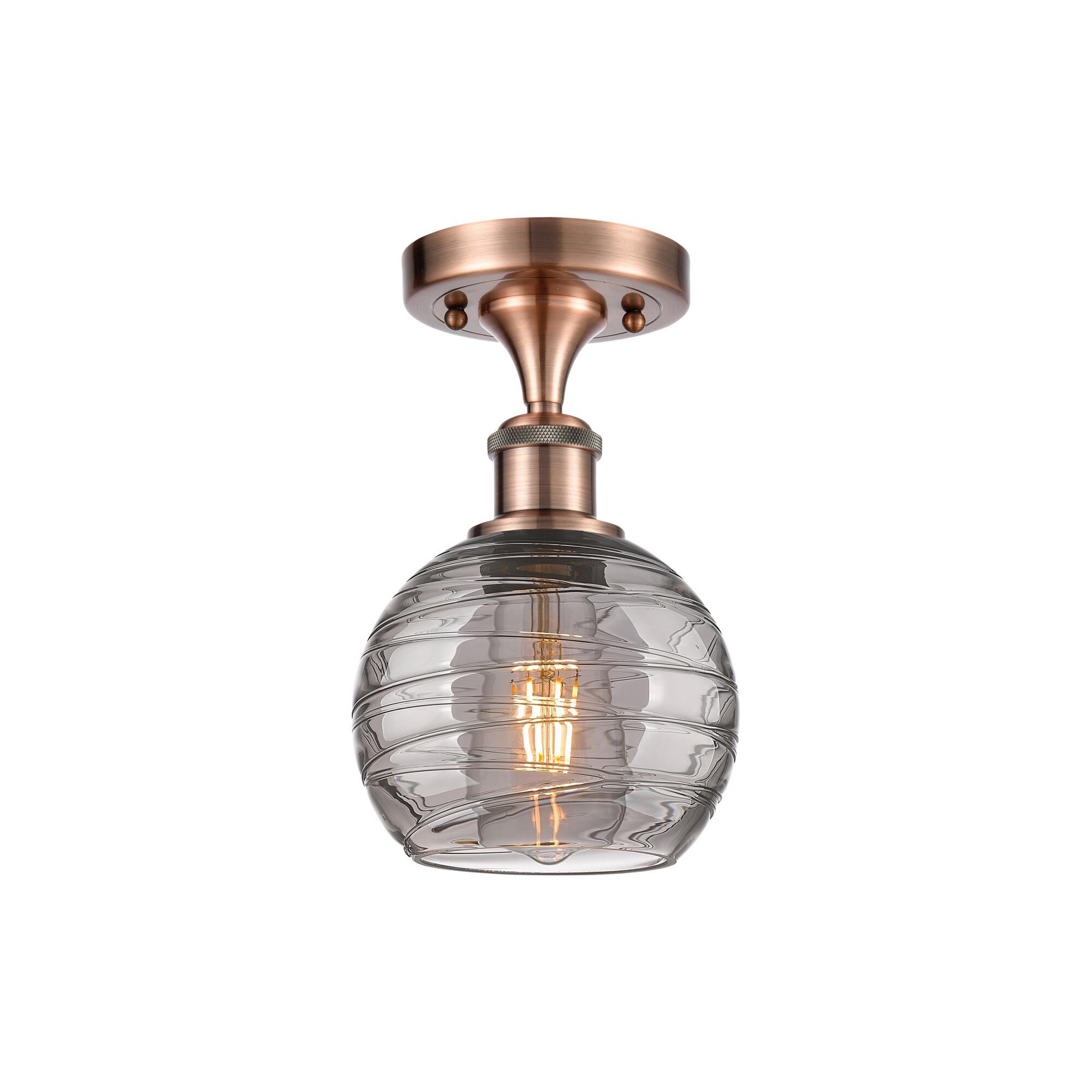 Shown in Antique Copper finish and Light Smoke Deco Swirl glass