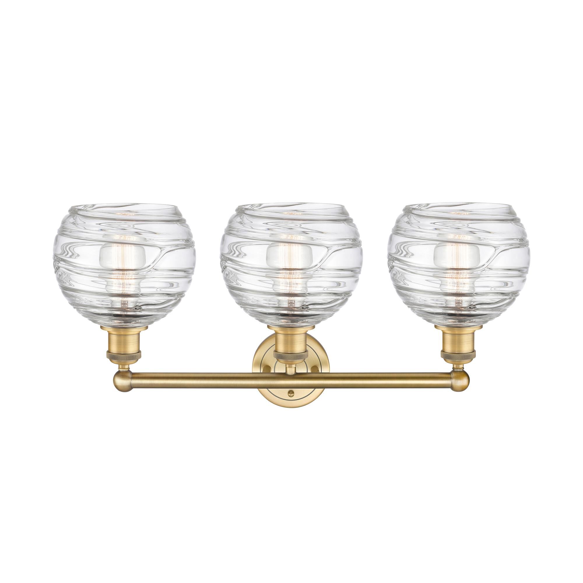 Shown in Brushed Brass finish and Clear Deco Swirl glass