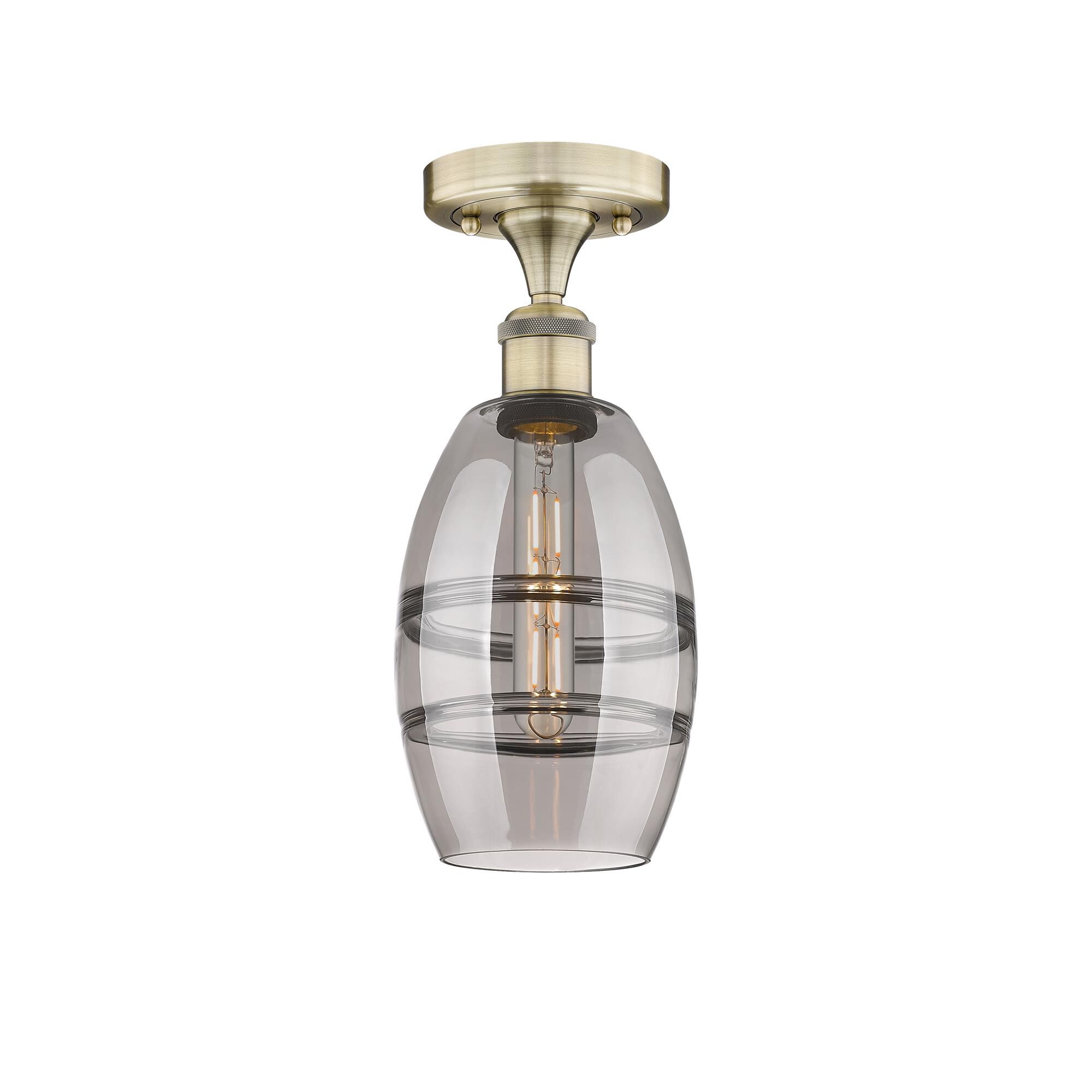 Shown in Antique Brass finish and Light Smoke glass
