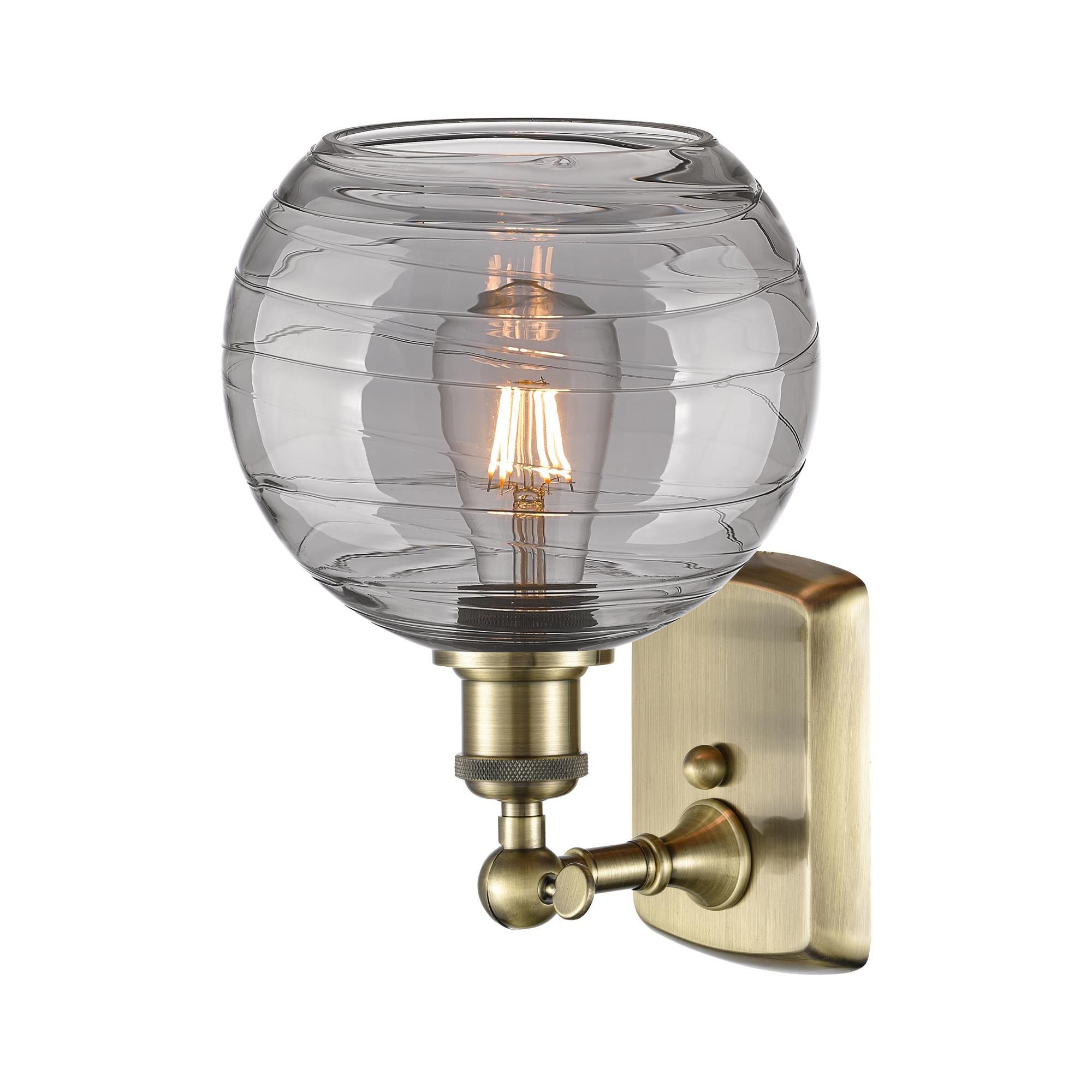 Shown in Antique Brass finish and Light Smoke Deco Swirl glass