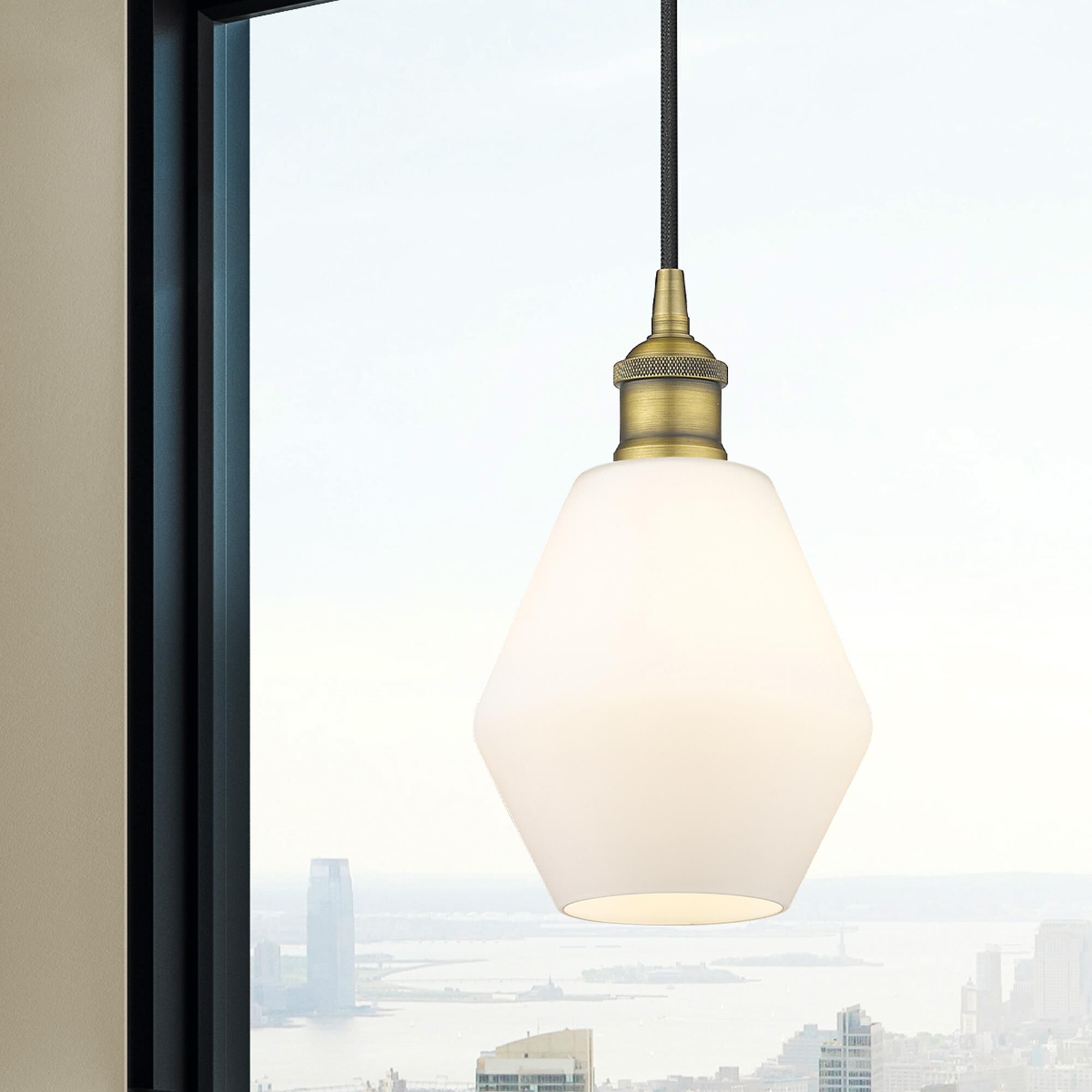 Shown in Brushed Brass finish and Matte White glass