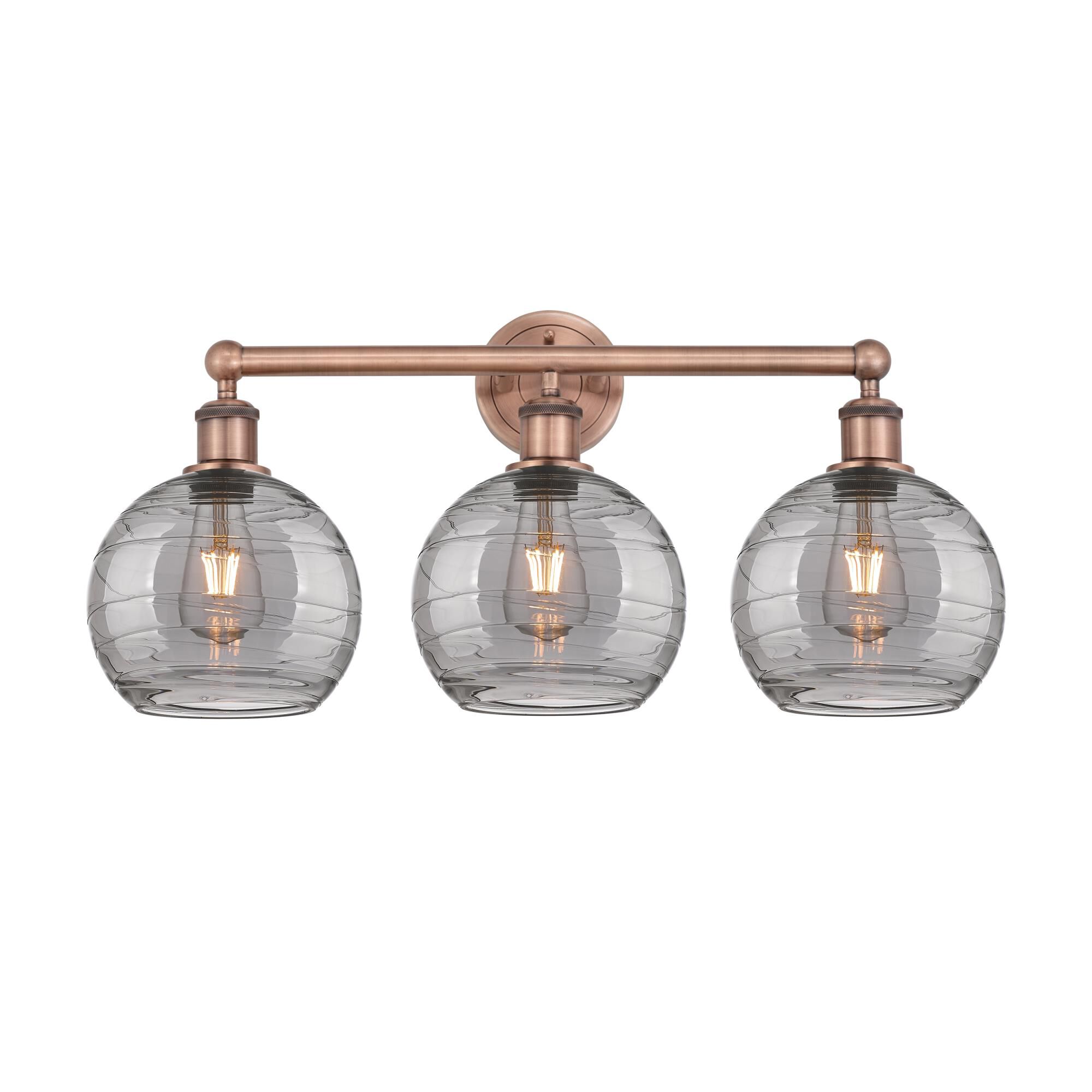 Shown in Antique Copper finish and Light Smoke Deco Swirl glass