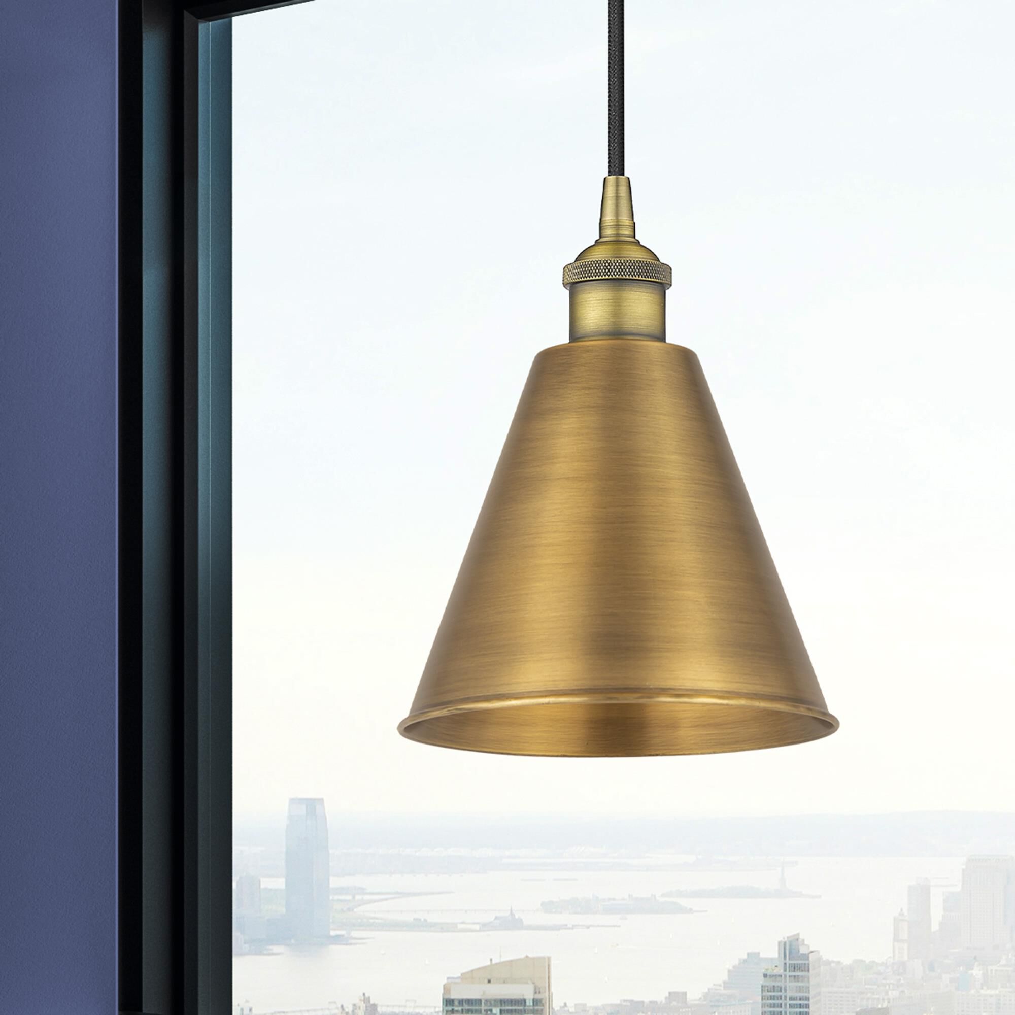 Shown in Brushed Brass finish and Matte Black Edison Cone shade