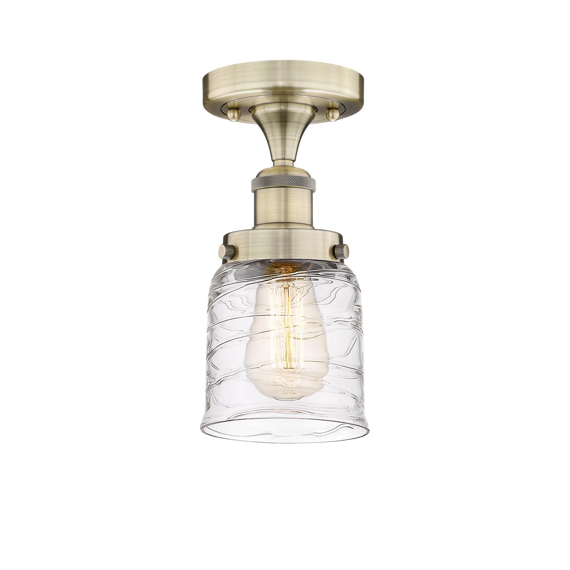 Shown in Antique Brass finish and Clear Deco Swirl glass
