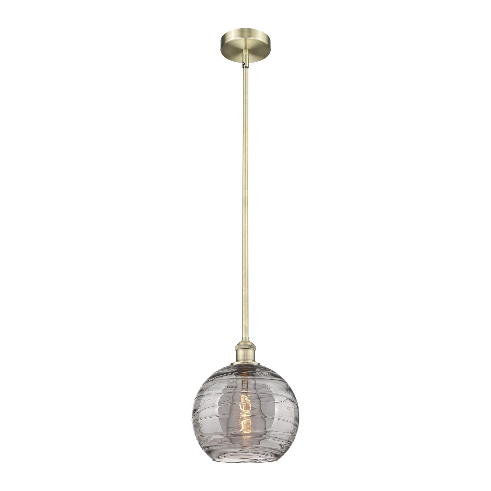 Shown in Antique Brass finish and Light Smoke Deco Swirl glass