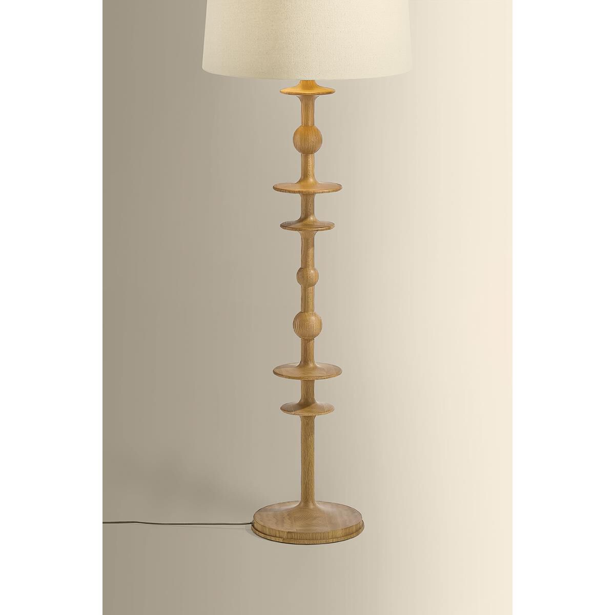 Shown in Aged Brass finish and Wheat Linen shade