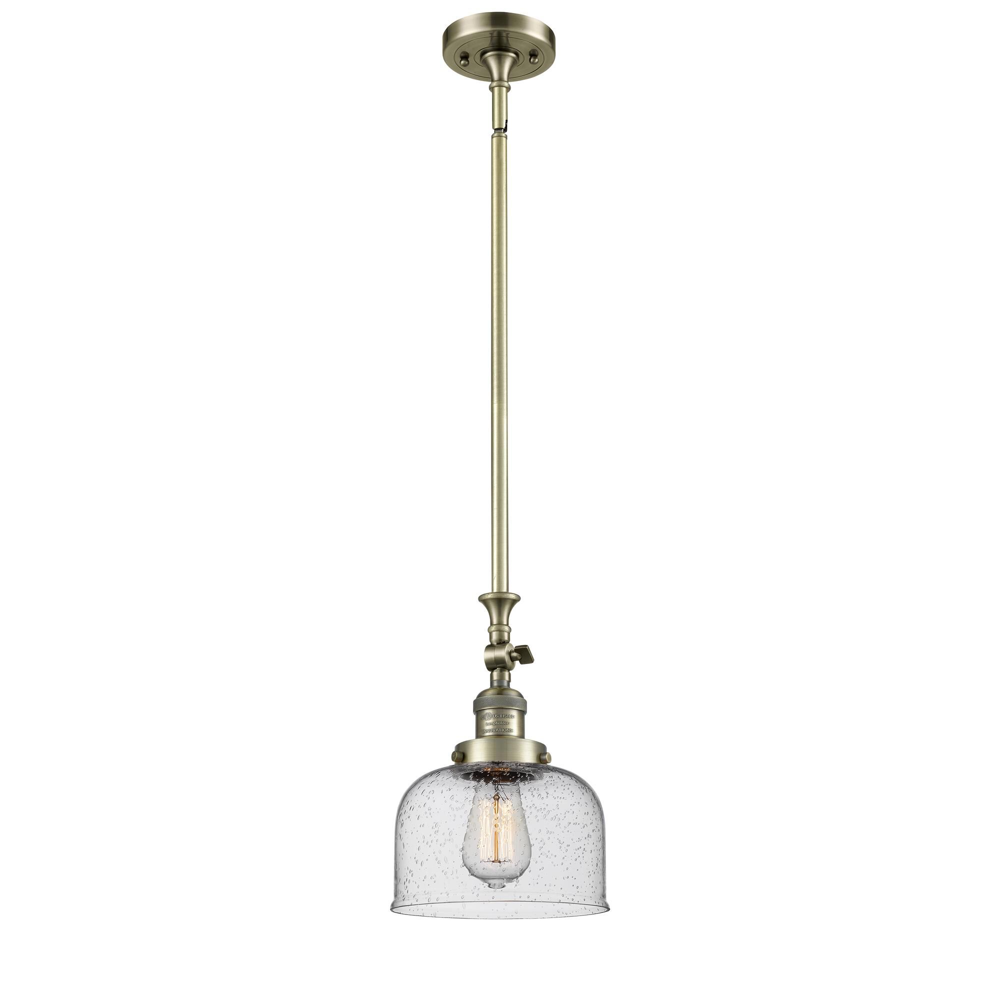 Shown in Antique Brass finish and Seedy glass
