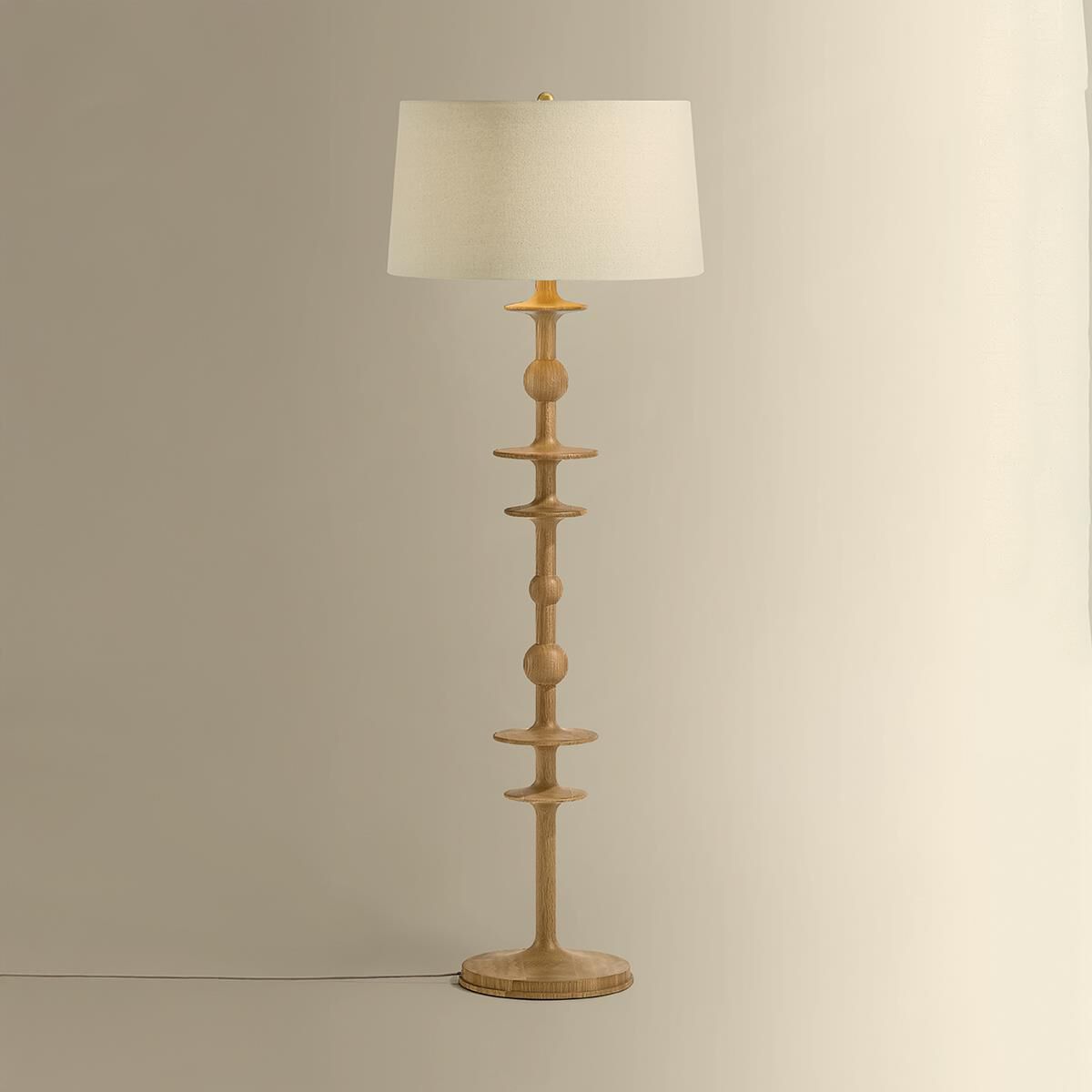 Shown in Aged Brass finish and Wheat Linen shade