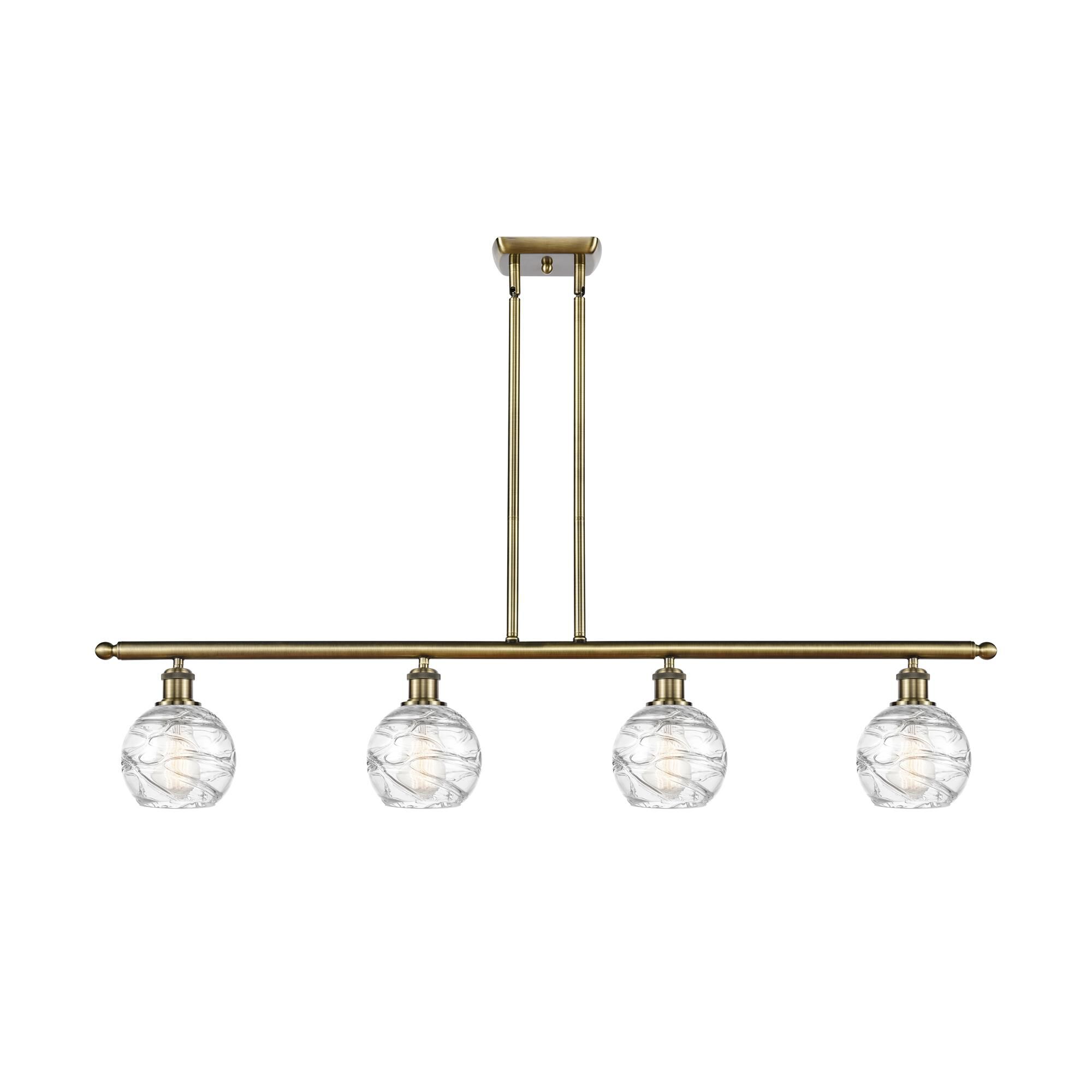 Shown in Antique Brass finish and Clear Deco Swirl glass