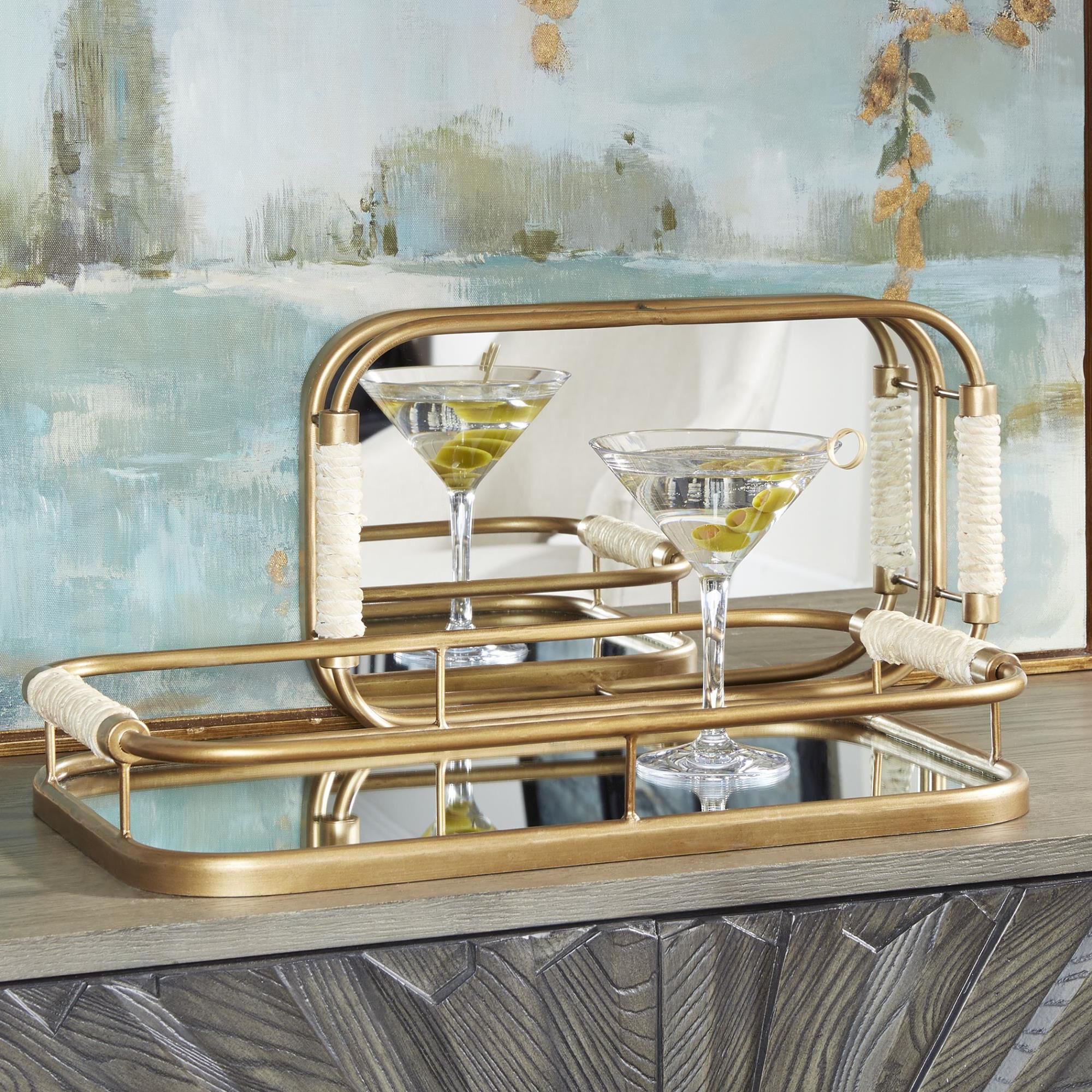 Shown in Set Of Two Metal Trays Are Finished In Brushed Gold With Natural Rope Wrapped Handles And Mirrored B finish