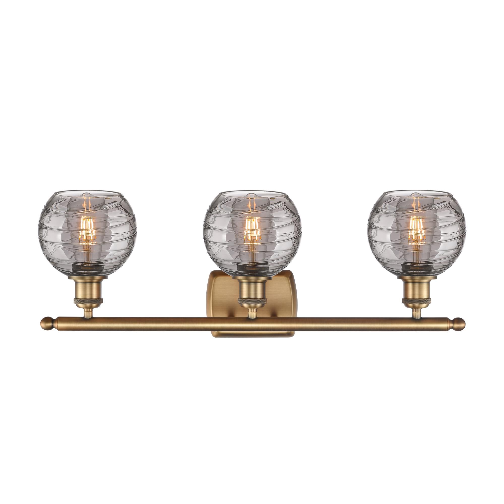 Shown in Brushed Brass finish and Light Smoke Deco Swirl glass