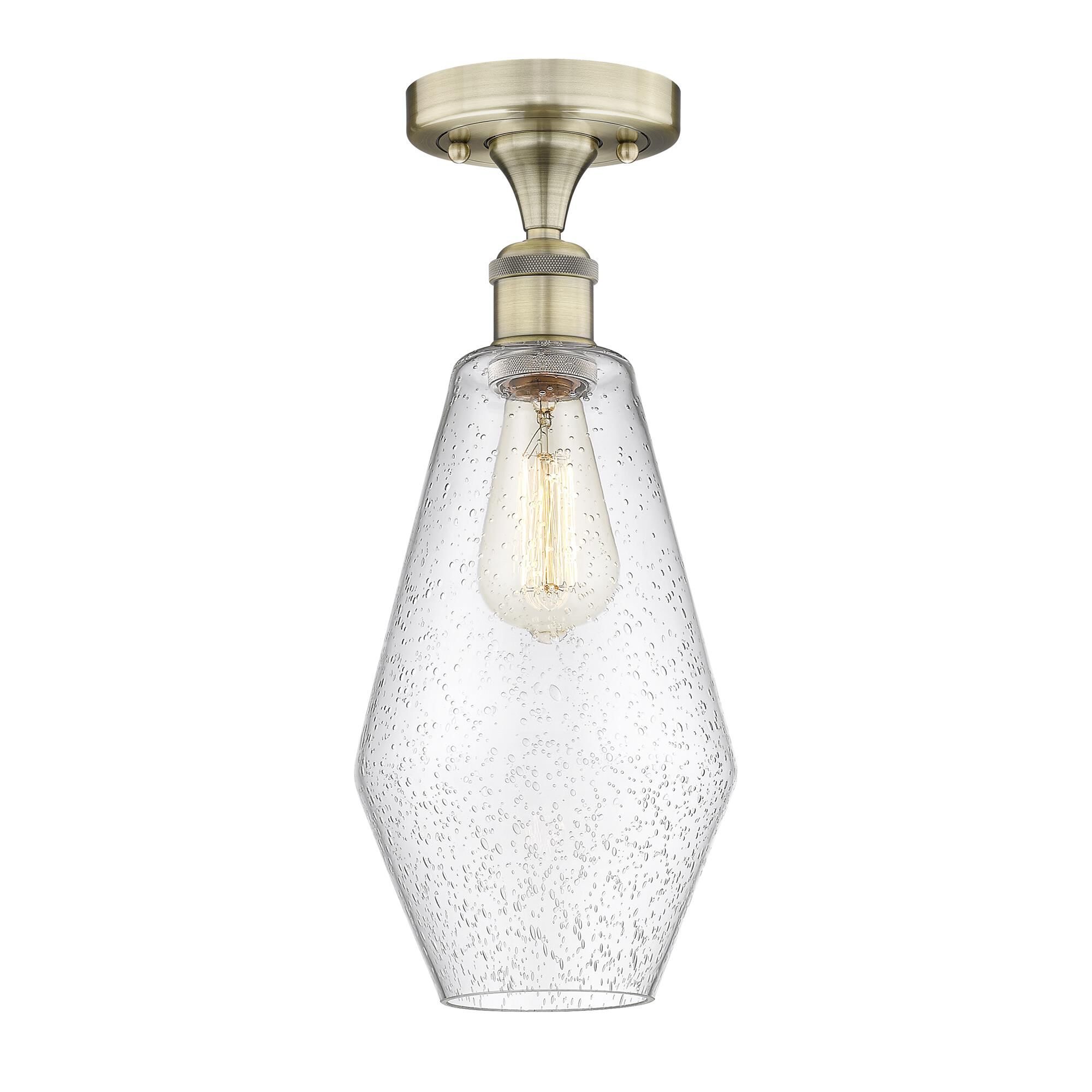 Shown in Antique Brass finish and Seedy glass