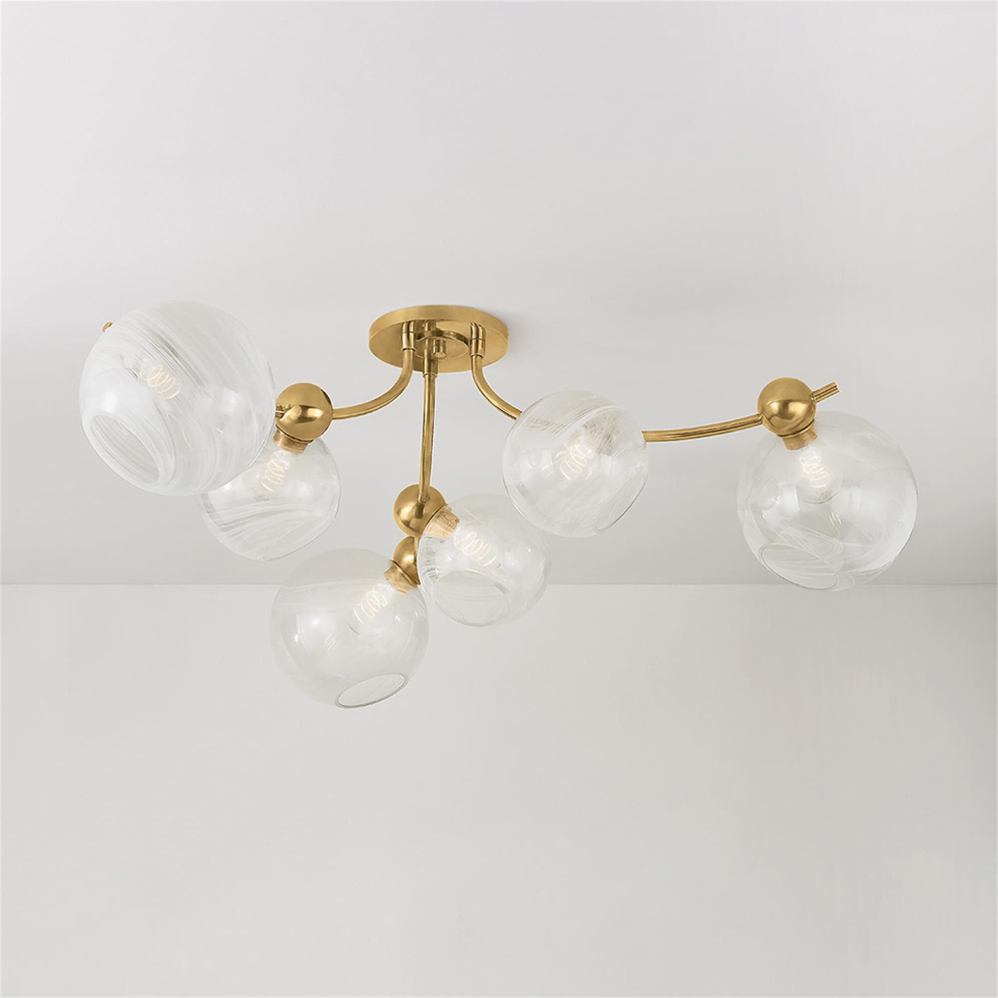 Shown in Vintage Brass finish and Remolino Blanco glass