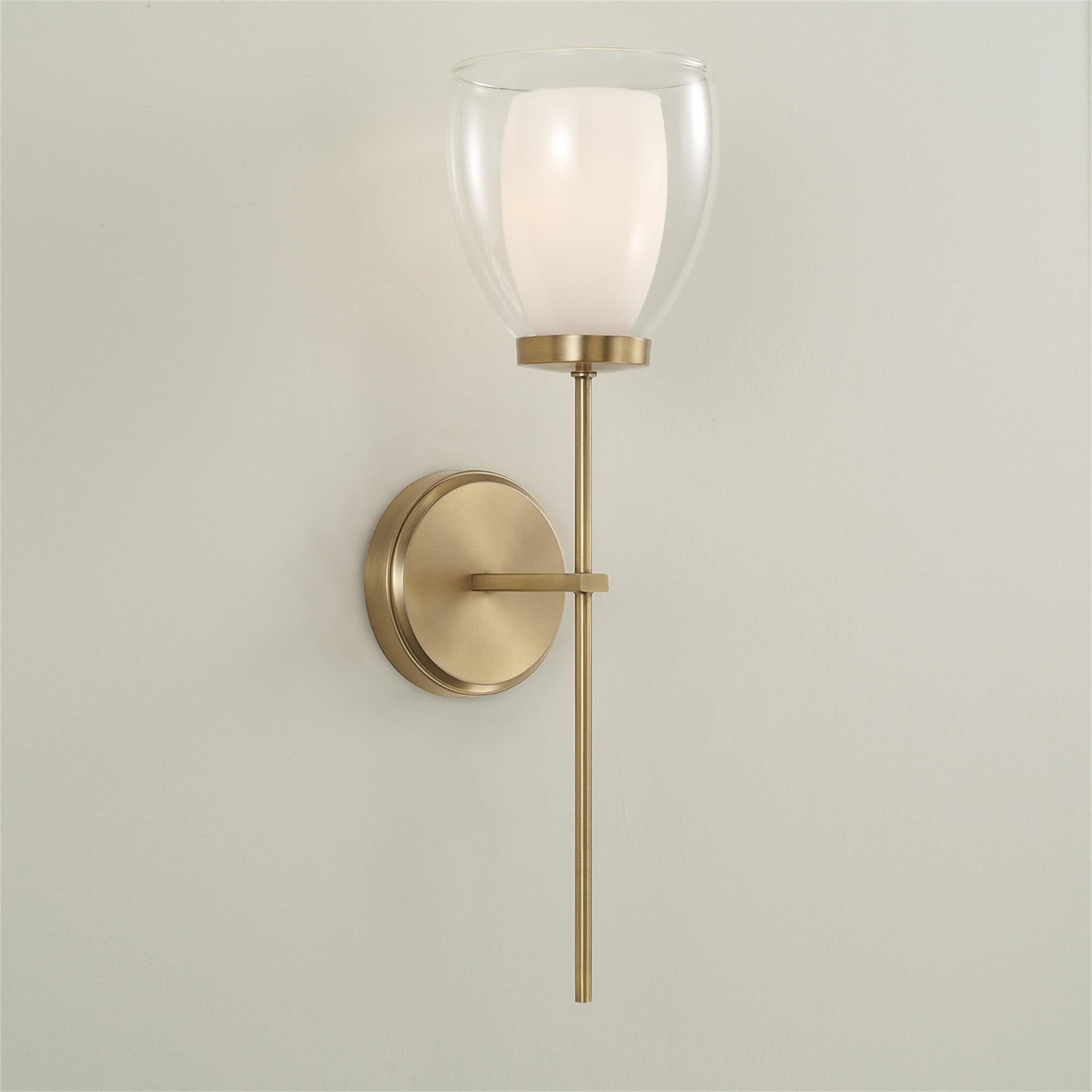 Shown in Aged Brass finish and Layered White And Clear glass