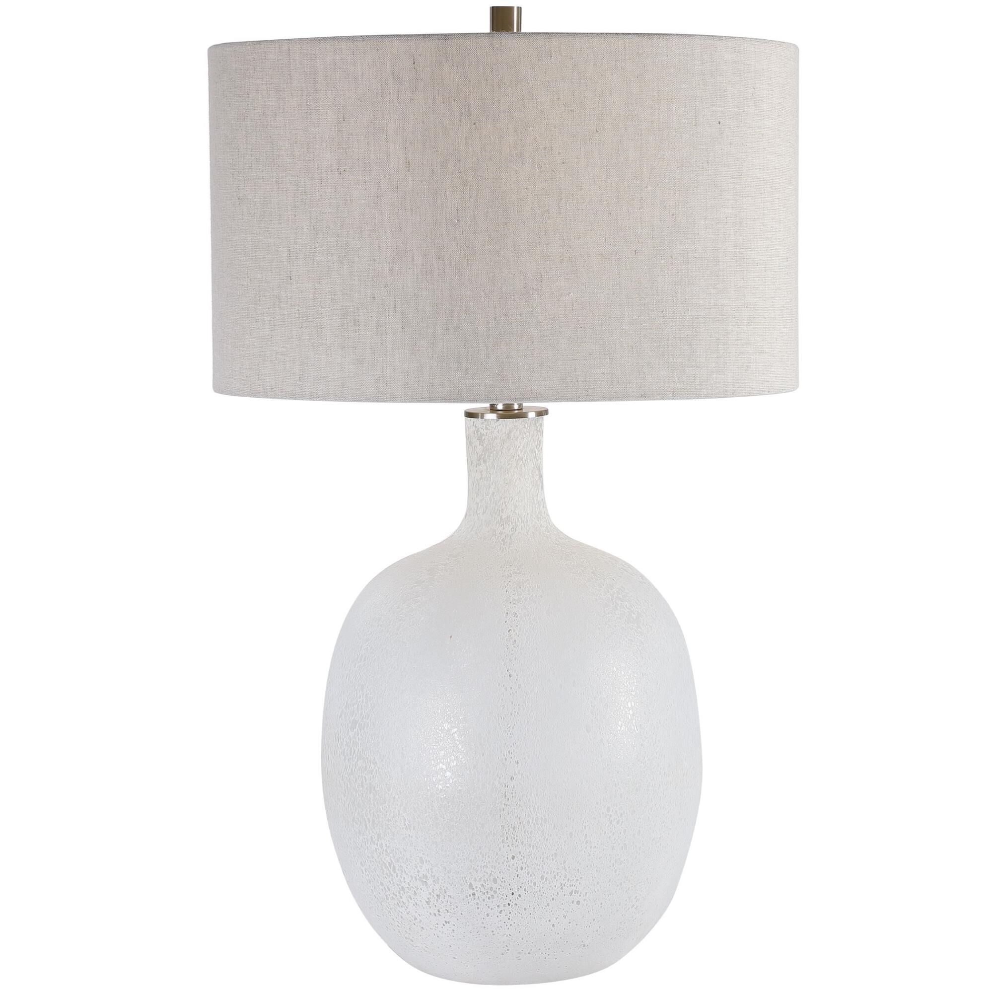 Shown in Beautiful And Functional, This Table Lamp Features A Glass Base Finished In A Heavily Textured, Mott finish and Round Hardback Drum shade