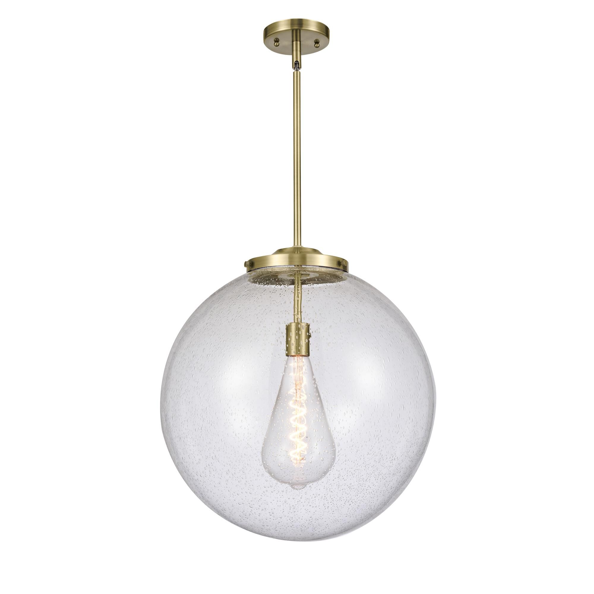 Shown in Antique Brass finish and Seedy Beacon glass