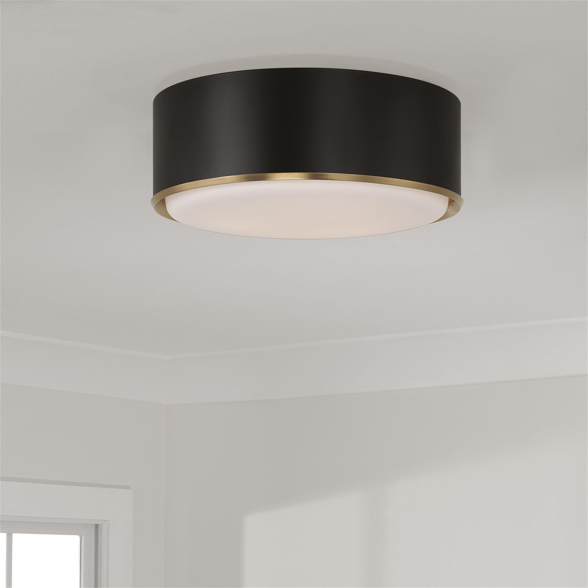 Shown in Matte Brass And Black finish and Soft White glass