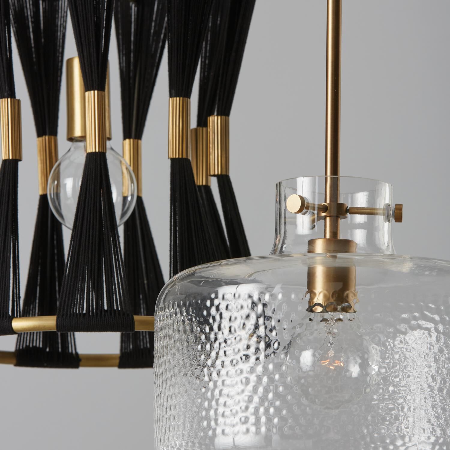 Shown in Aged Brass finish and Clear Pebbled glass