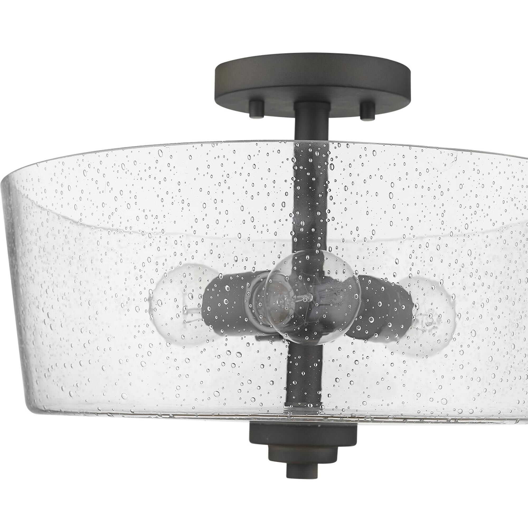 Shown in Oil-Rubbed Bronze finish and Clear glass and Clear, Seeded Drum Shaped Glass shade