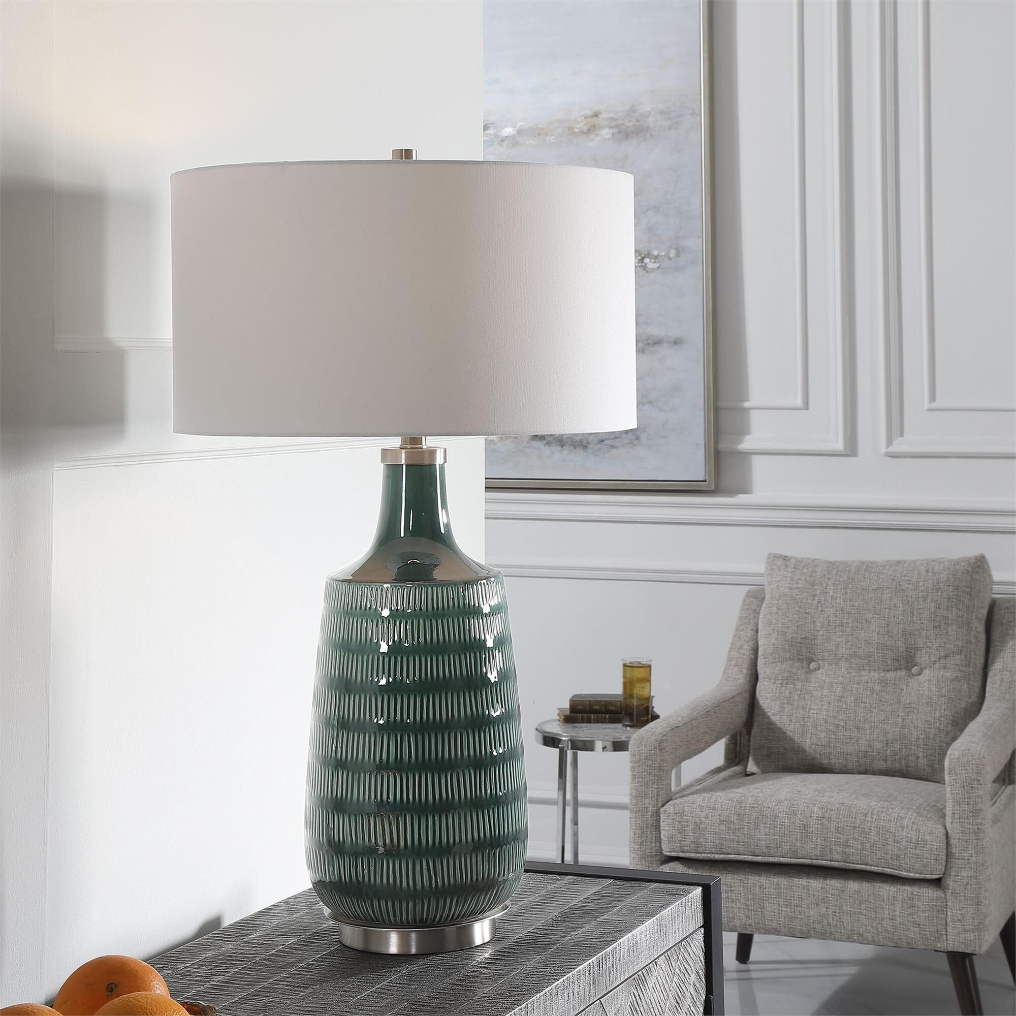 Shown in Finished In A Stunning Deep Teal Glaze, This Ceramic Table Lamp Features Hand Carved Organic Vertica finish and Round Drum Hardback shade