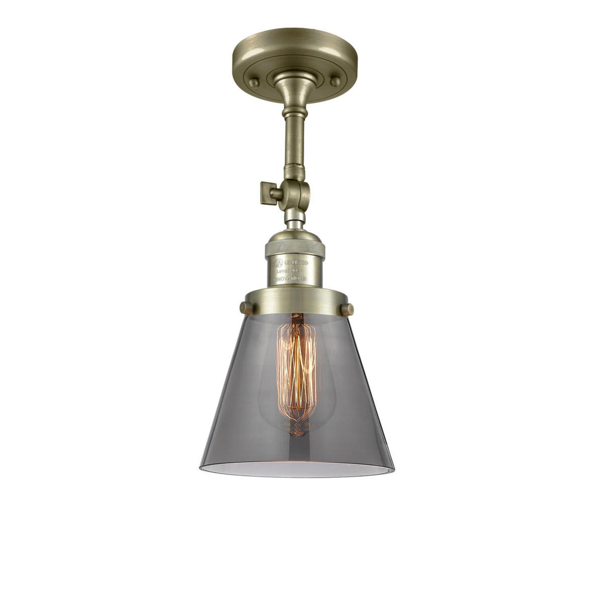 Shown in Antique Brass finish and Smoked glass and None accent