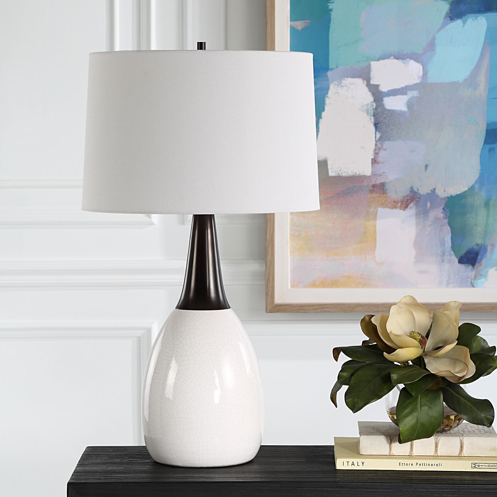 Shown in This Unique Table Lamp Seamlessly Blends Elegance And Uniqueness Into One Captivating Design. The Cr finish and Round Hardback shade