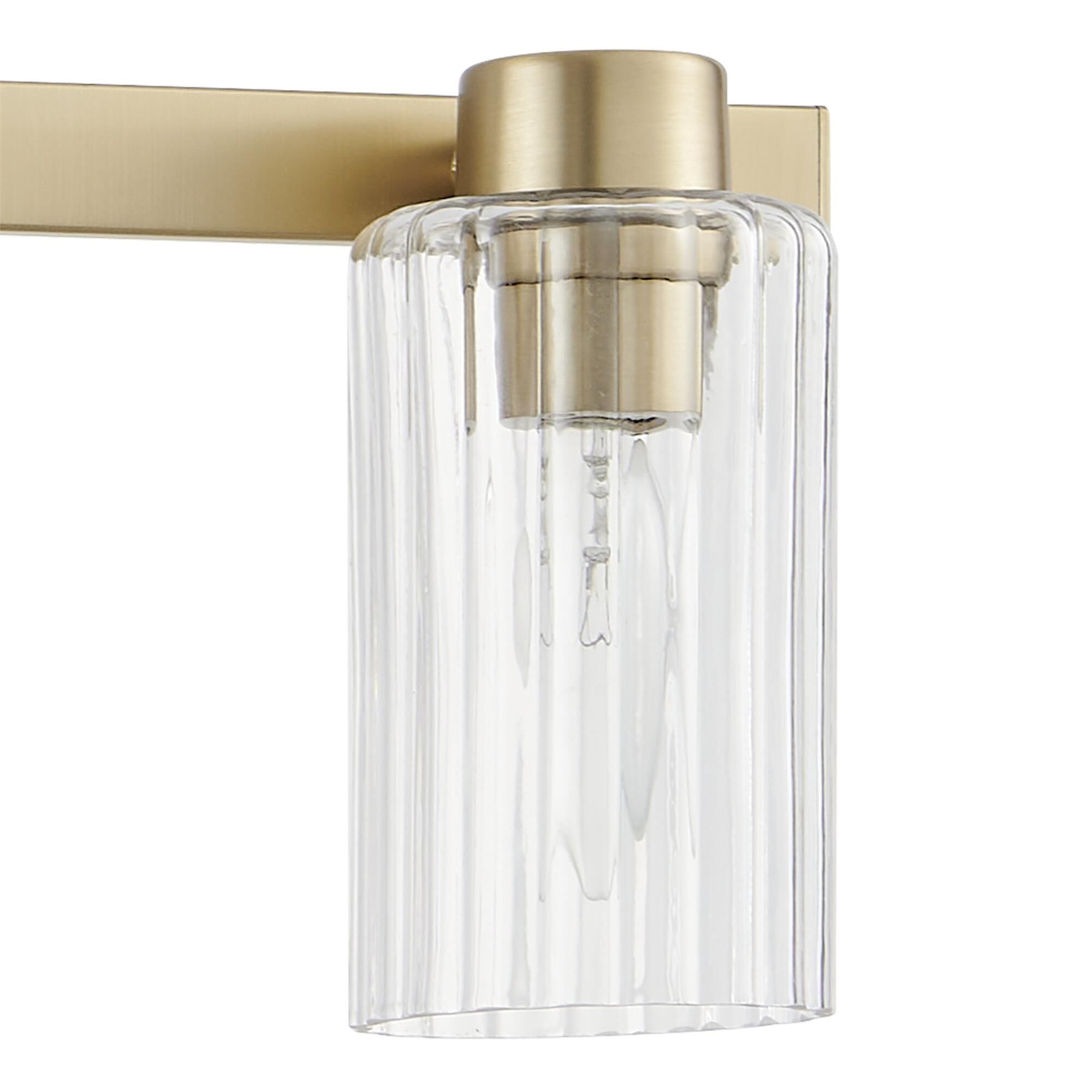 Shown in Champagne Gold finish and Clear Ribbed glass