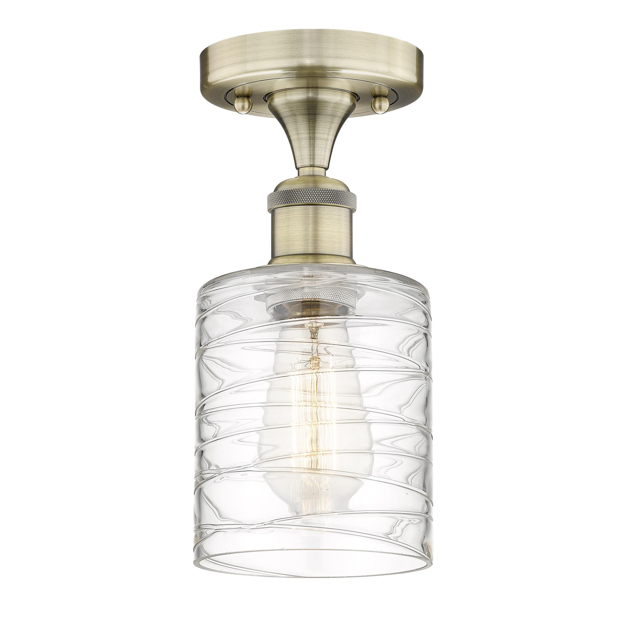 Shown in Antique Brass finish and Deco Swirl glass