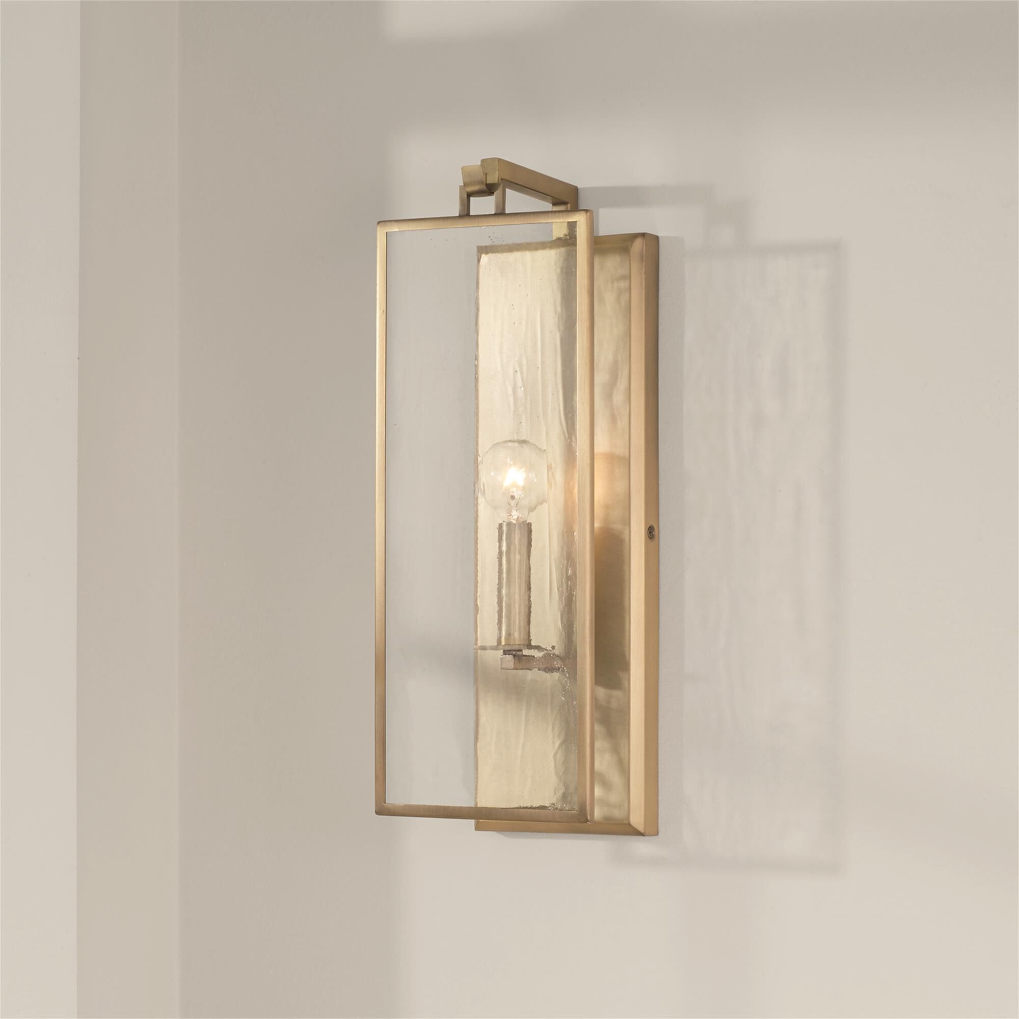 Shown in Aged Brass finish and Antiqued Rain glass