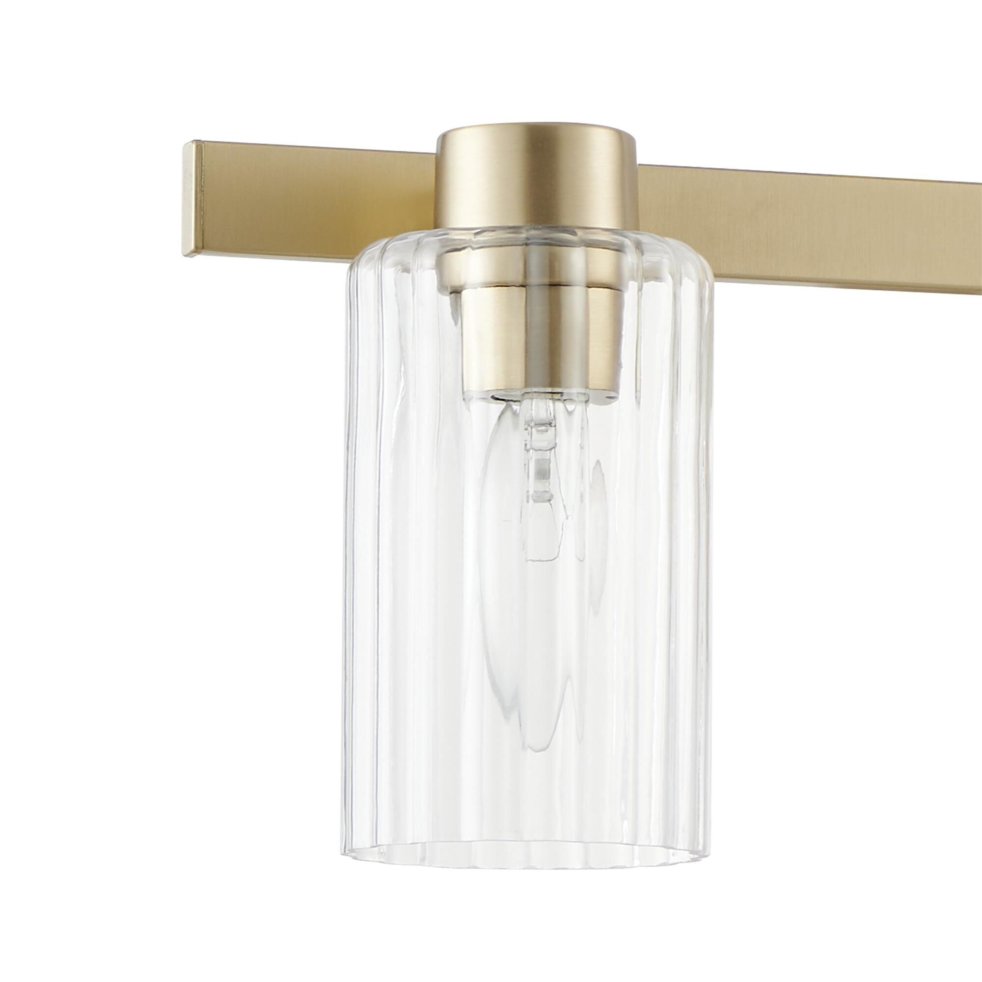 Shown in Champagne Gold finish and Clear Ribbed glass