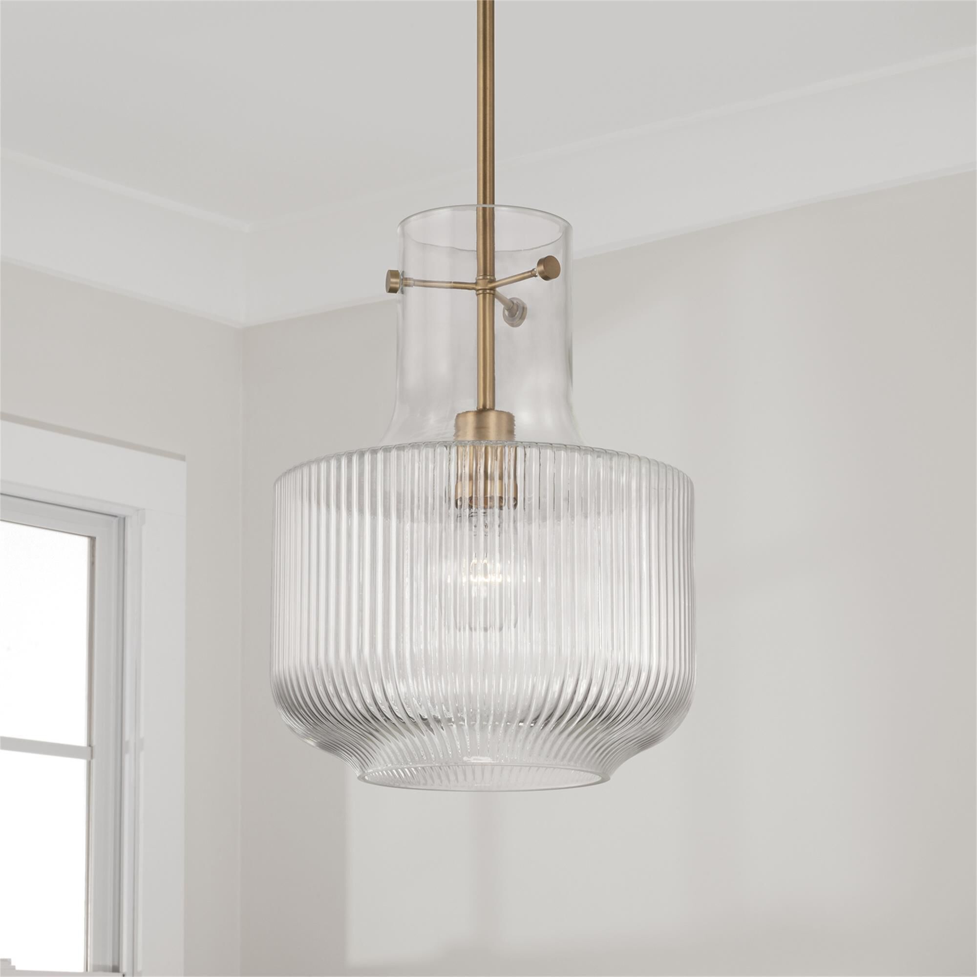 Shown in Aged Brass finish and Clear Fluted glass