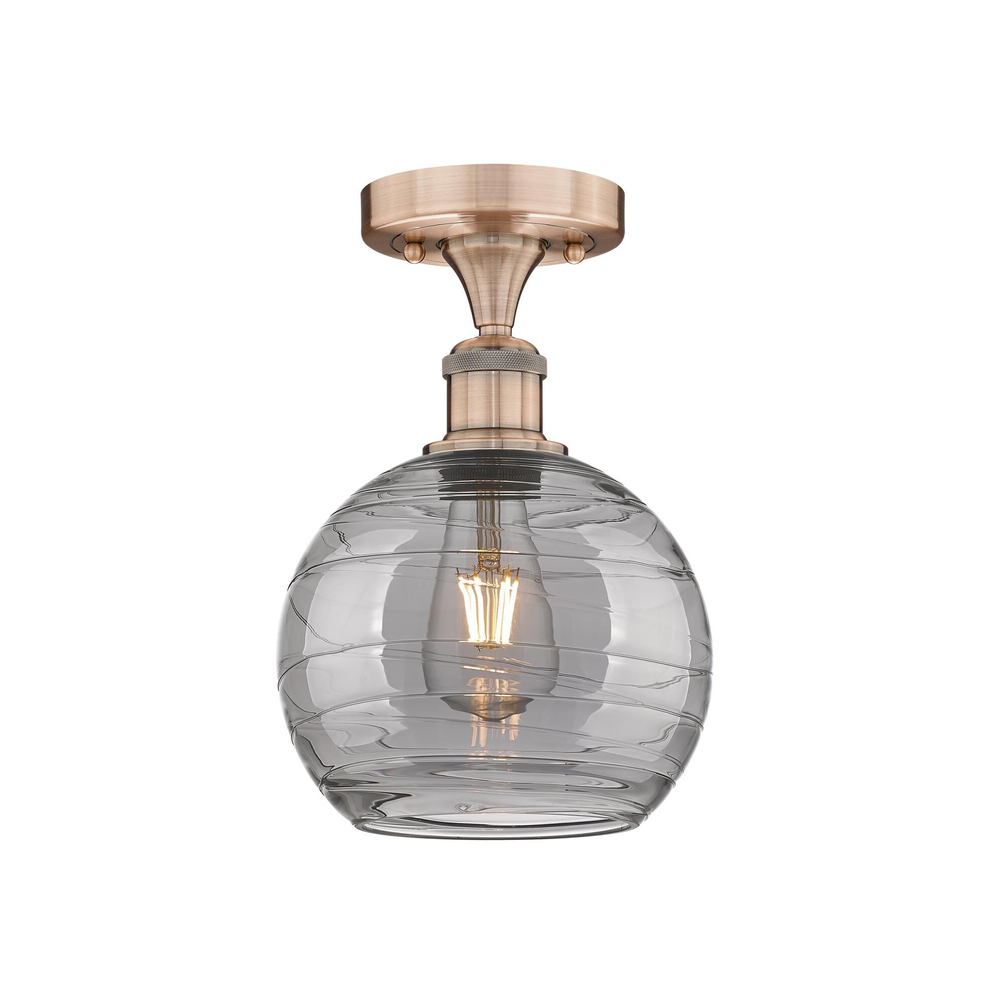 Shown in Antique Copper finish and Light Smoke Deco Swirl glass