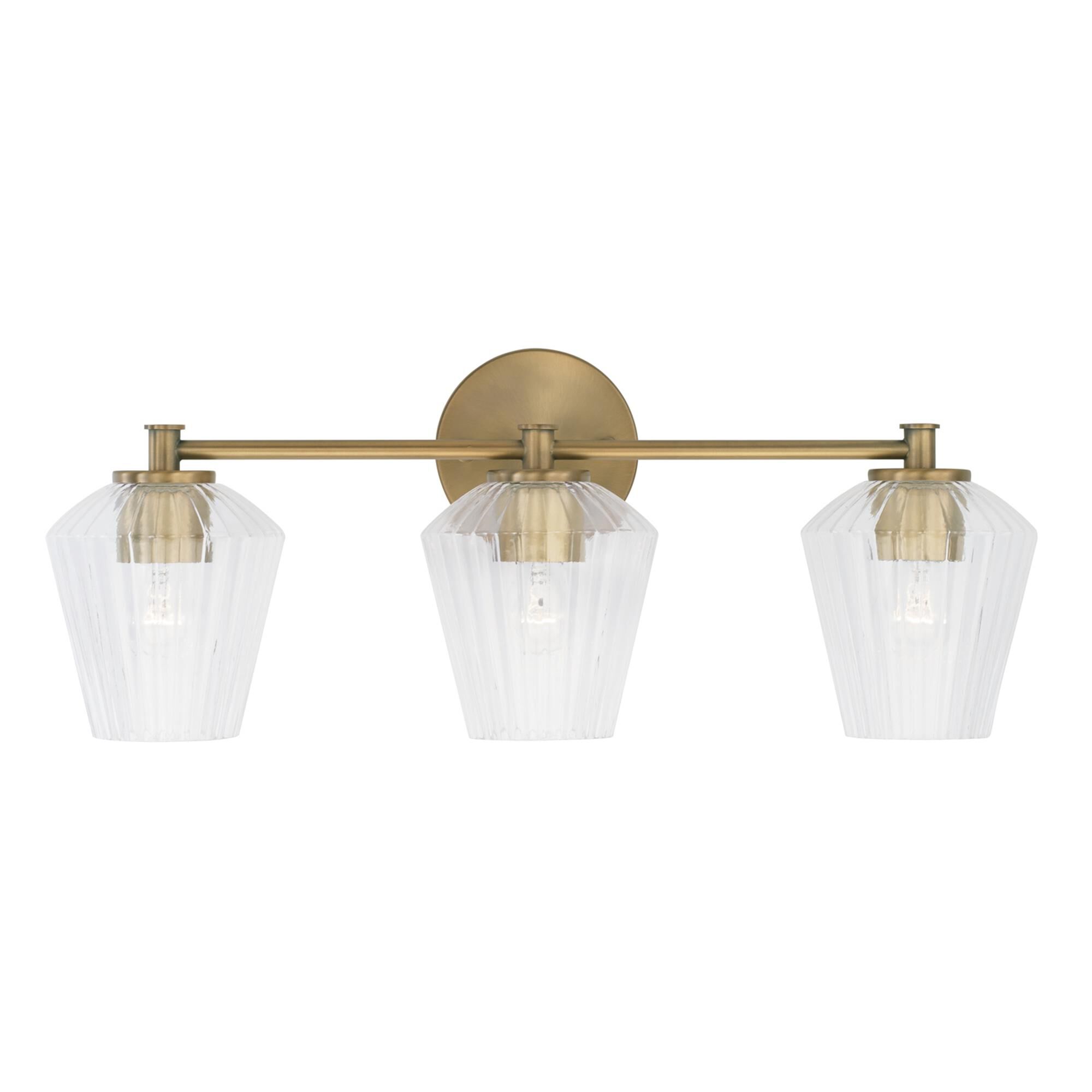 Shown in Aged Brass finish and Clear Fluted glass