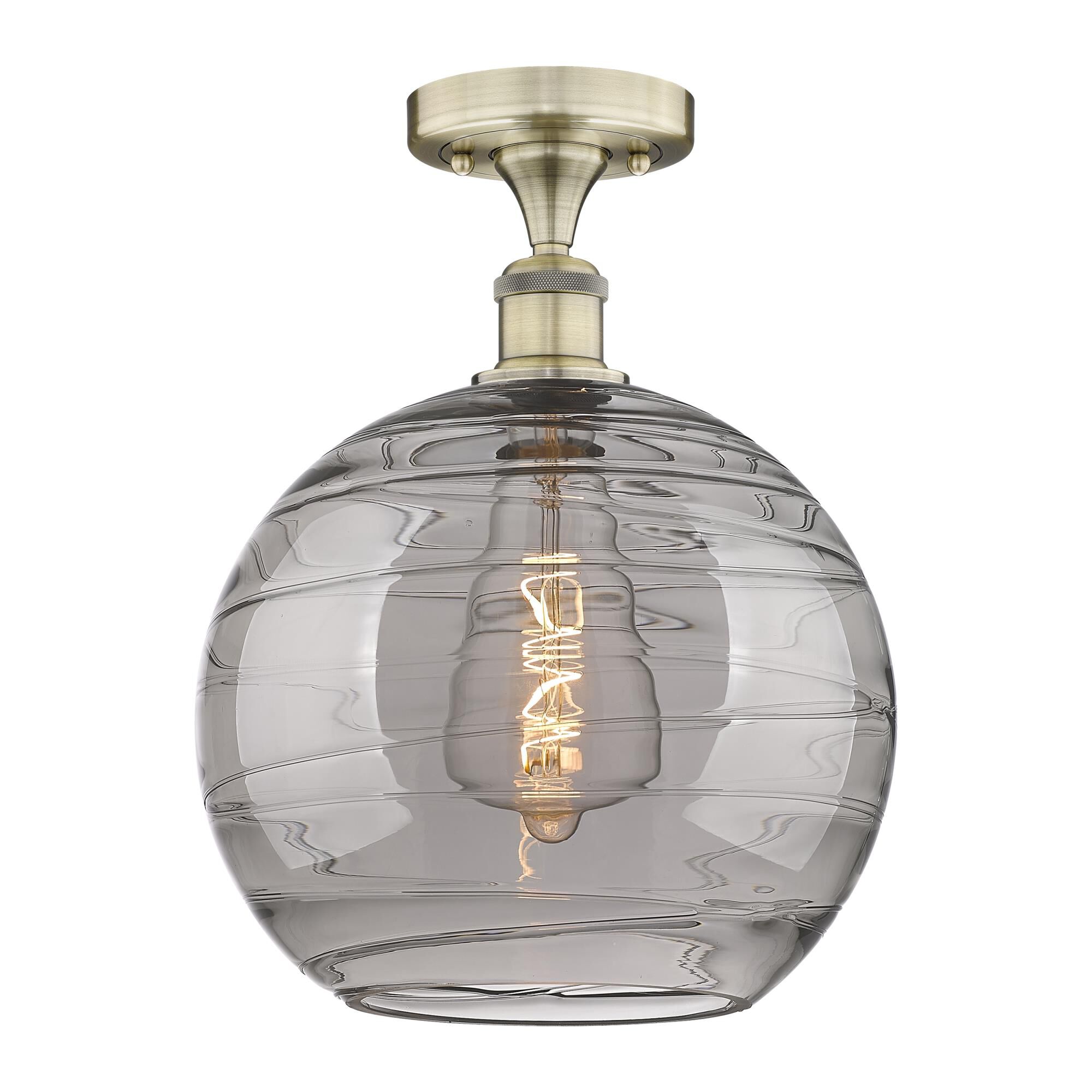 Shown in Antique Brass finish and Light Smoke Deco Swirl glass